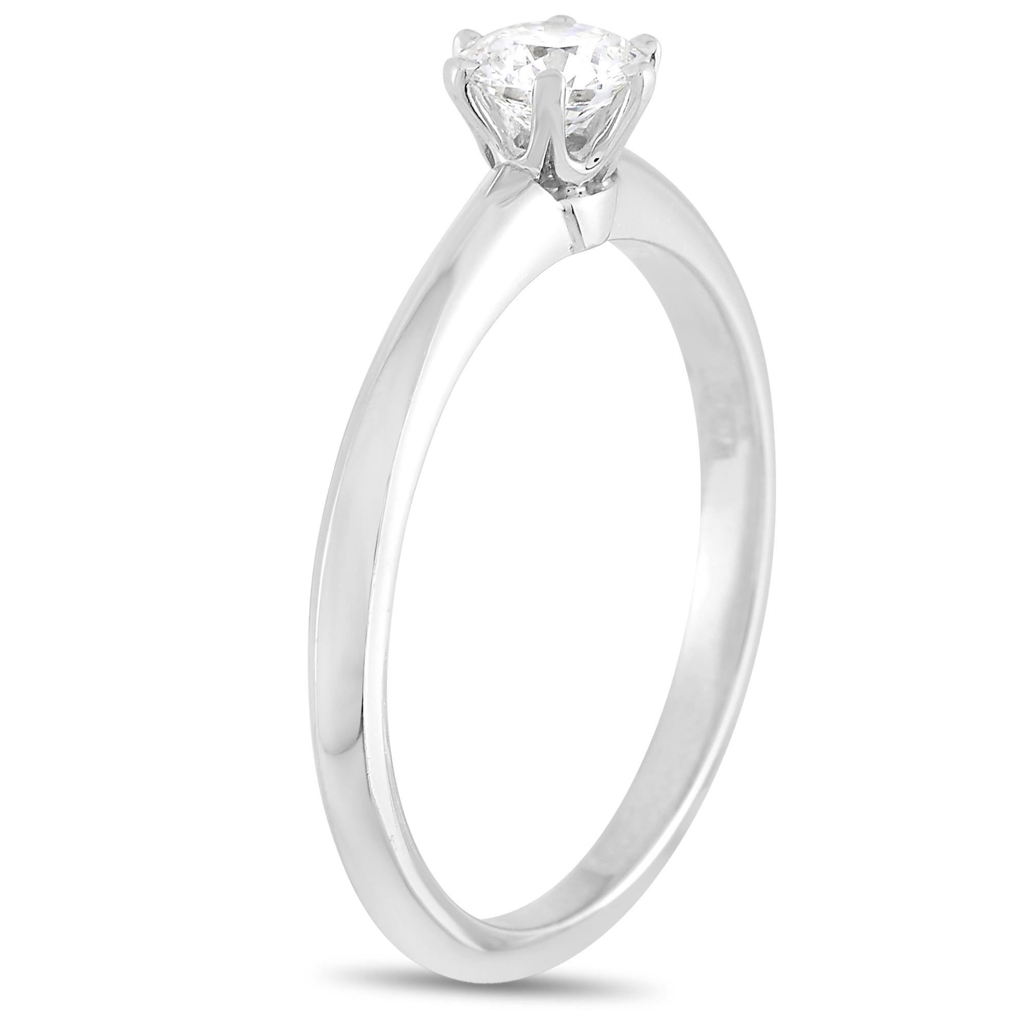 Lovers of classic lines will be attracted to the dainty silhouette of this ring. The Tiffany & Co. Setting Platinum 0.30 ct Diamond F-VS1 Engagement Ring (3.3g) exudes a timeless appeal honored for its elegant simplicity. The round brilliant diamond