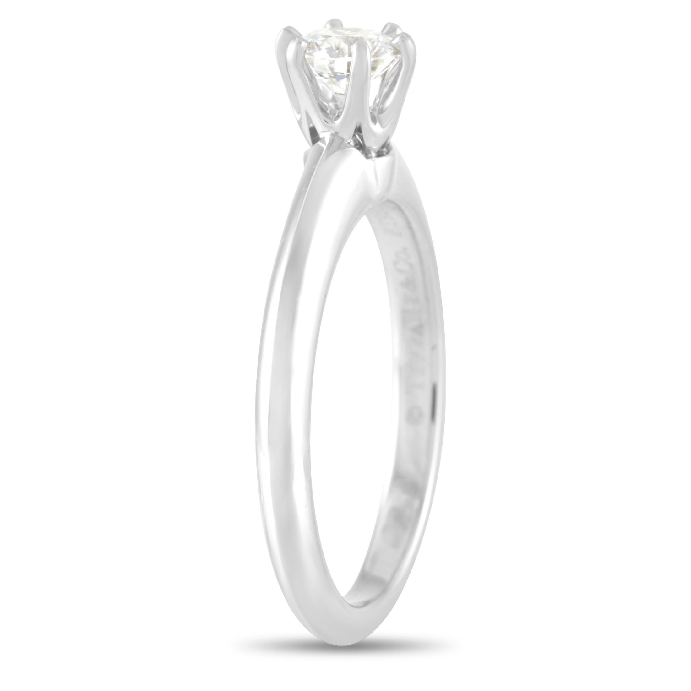 Created with timeless beauty and impressive craftsmanship, this Tiffany & Co. Platinum 0.31 ct Diamond Solitaire Ring will get your beloved staring at it for hours on end. It showcases a classic design that's 100% Tiffany. It features a platinum