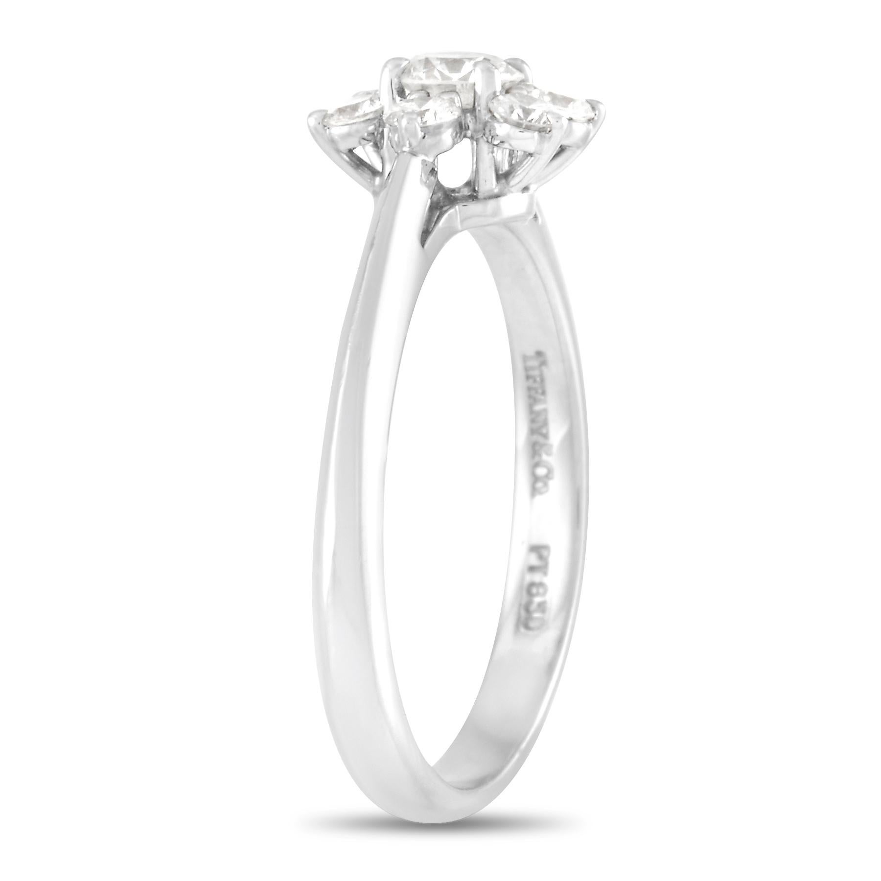 This Tiffany & Co Platinum 0.35 carat Diamond Halo Cocktail Ring is an elegant piece made with platinum to last the tests of time. The band is made with platinum and set with a total of 0.35 carats of round cut diamonds with a halo of smaller round