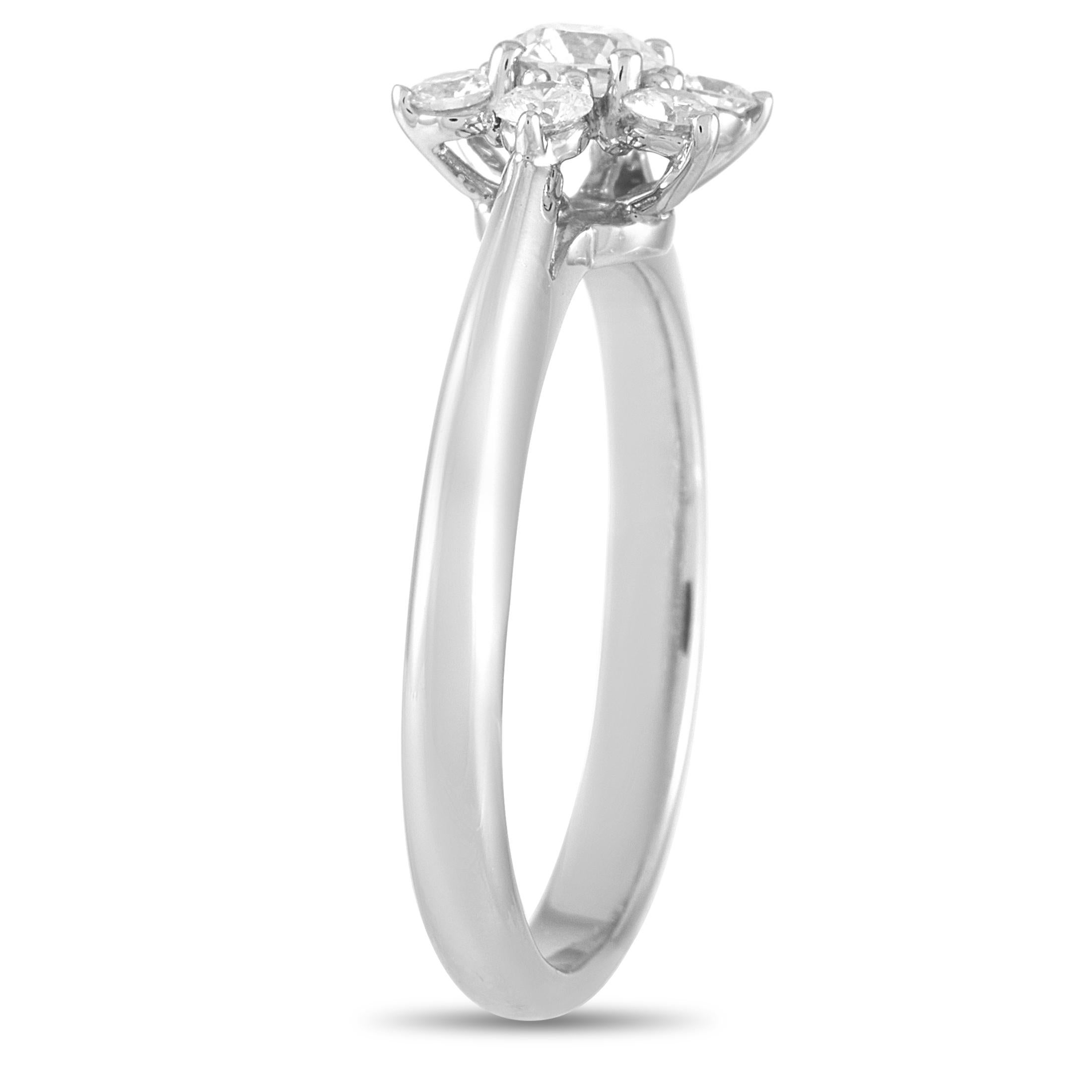 The Tiffany & Co. Platinum 0.50 ct Diamond Flower Cocktail Ring blooms with graceful beauty. A center diamond surrounded by six shimmering diamond petals makes up the chic centerpiece of this ring. The band measures 2mm thick and tapers toward the