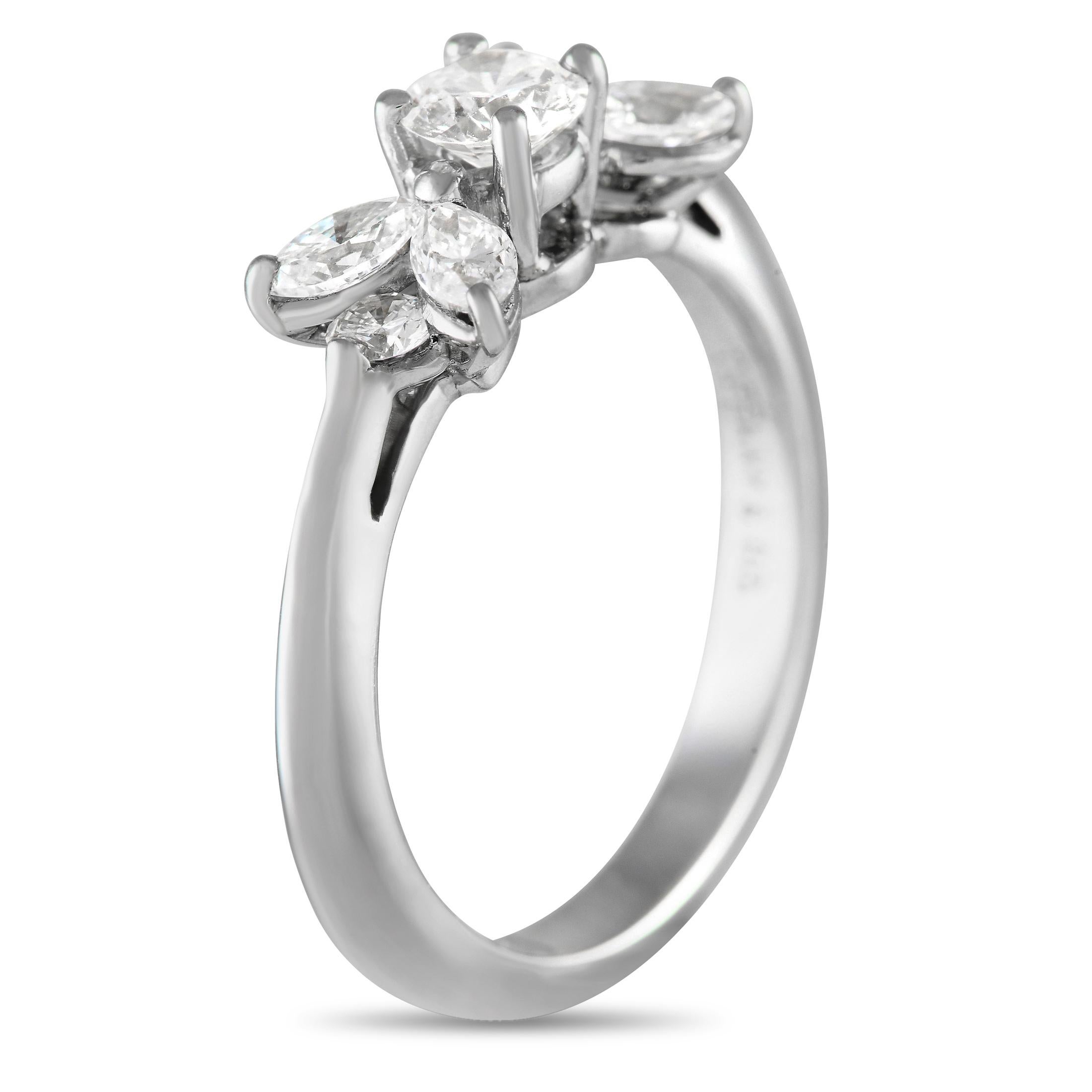 Exuding timeless elegance, this ring's beauty can certainly withstand trends. The ring is made out of 950 platinum and features a slender knife-edge shank. Sitting right on top of the central basket is a round diamond. On its left and right sides