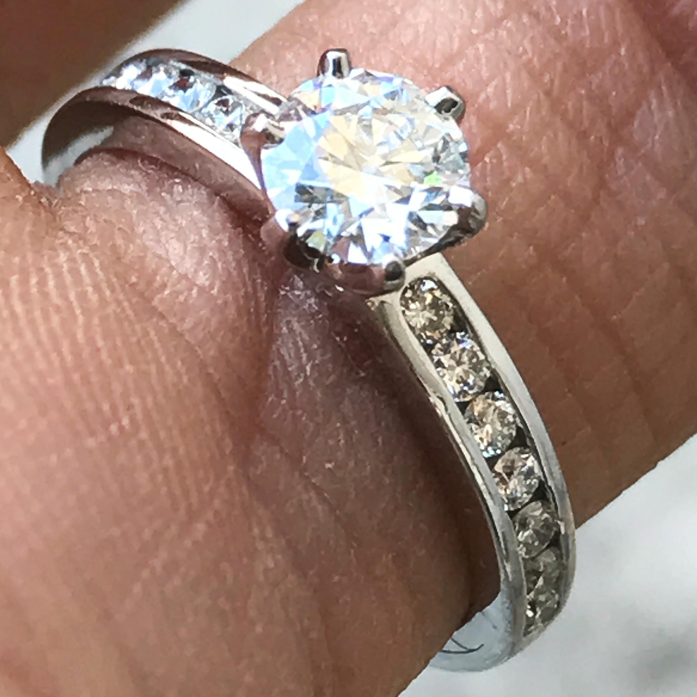 Tiffany & Co.  Plat 0.47 ct Modern Round Brilliant E VS1 Diamond Engagement Ring

14 round diamonds adorn the shank of the ring for an estimated total carat weight of 0.77 ct including the center stone.

Color : E (Colorless)

Clarity : VS1

Diamond