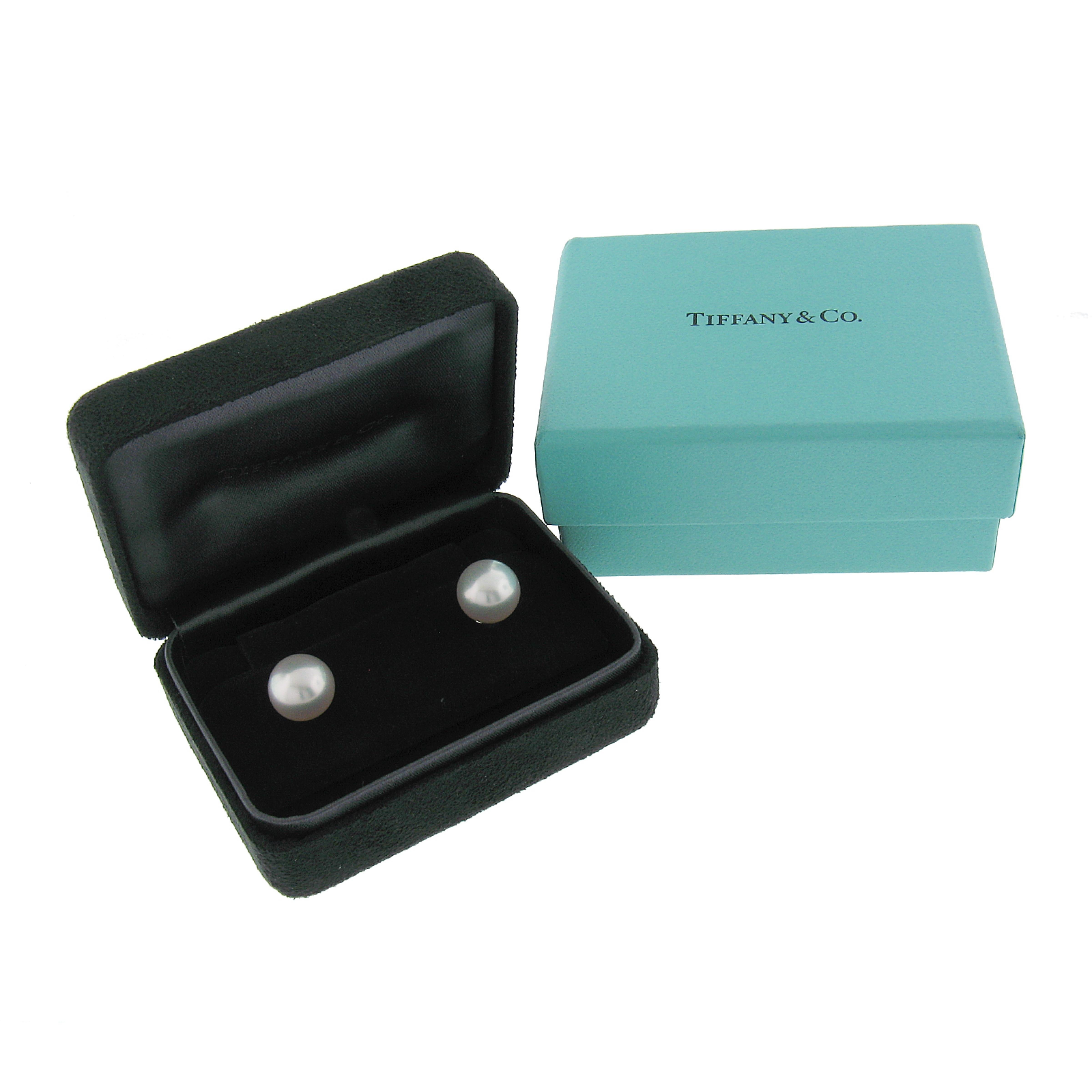 These gorgeous stud earrings by Tiffany & Co. and are crafted in solid platinum and feature an absolutely elegant classic design set with a high quality Akoya cultured pearl at their center. The pearls are very well matched showing an attractive