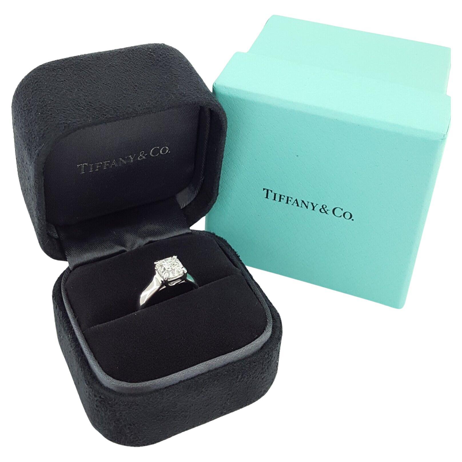 Tiffany & Co. Platinum 1.19 ct Lucida Square Brilliant Cut Diamond Solitaire Engagement Ring.
The ring weighs 5.1 grams, size 3.75 (can be resized to a larger size), the center stone is a Natural 1.19 ct Lucida Square Brilliant Cut diamond, G in