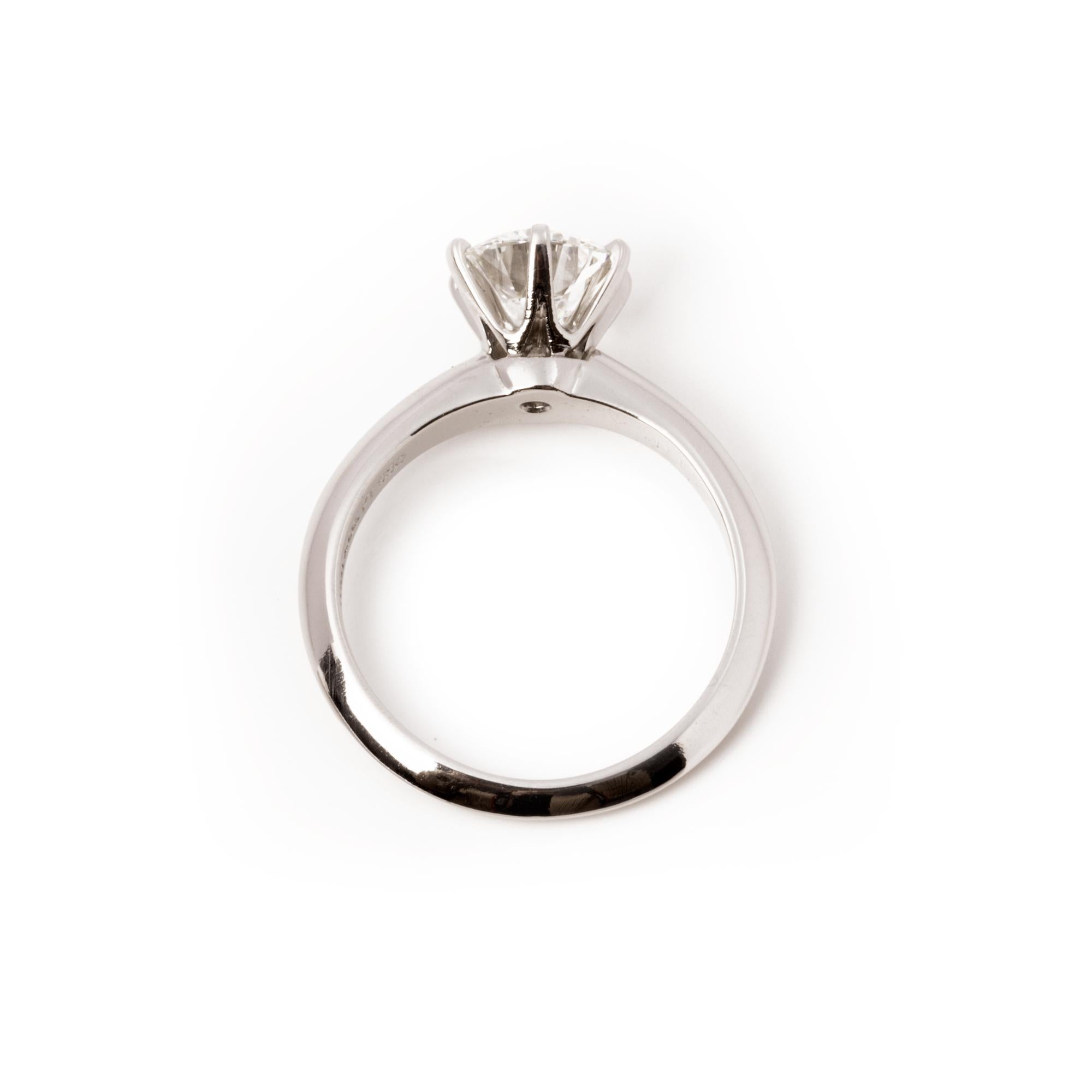 This ring by Tiffany & Co. features a solitaire round brilliant cut diamond totalling 1.1ct, clarity VS1 and colour H. Accompanied with it's original Tiffany box and certificate. UK ring size H, EU ring size 47, US ring size 4. This ring can be re
