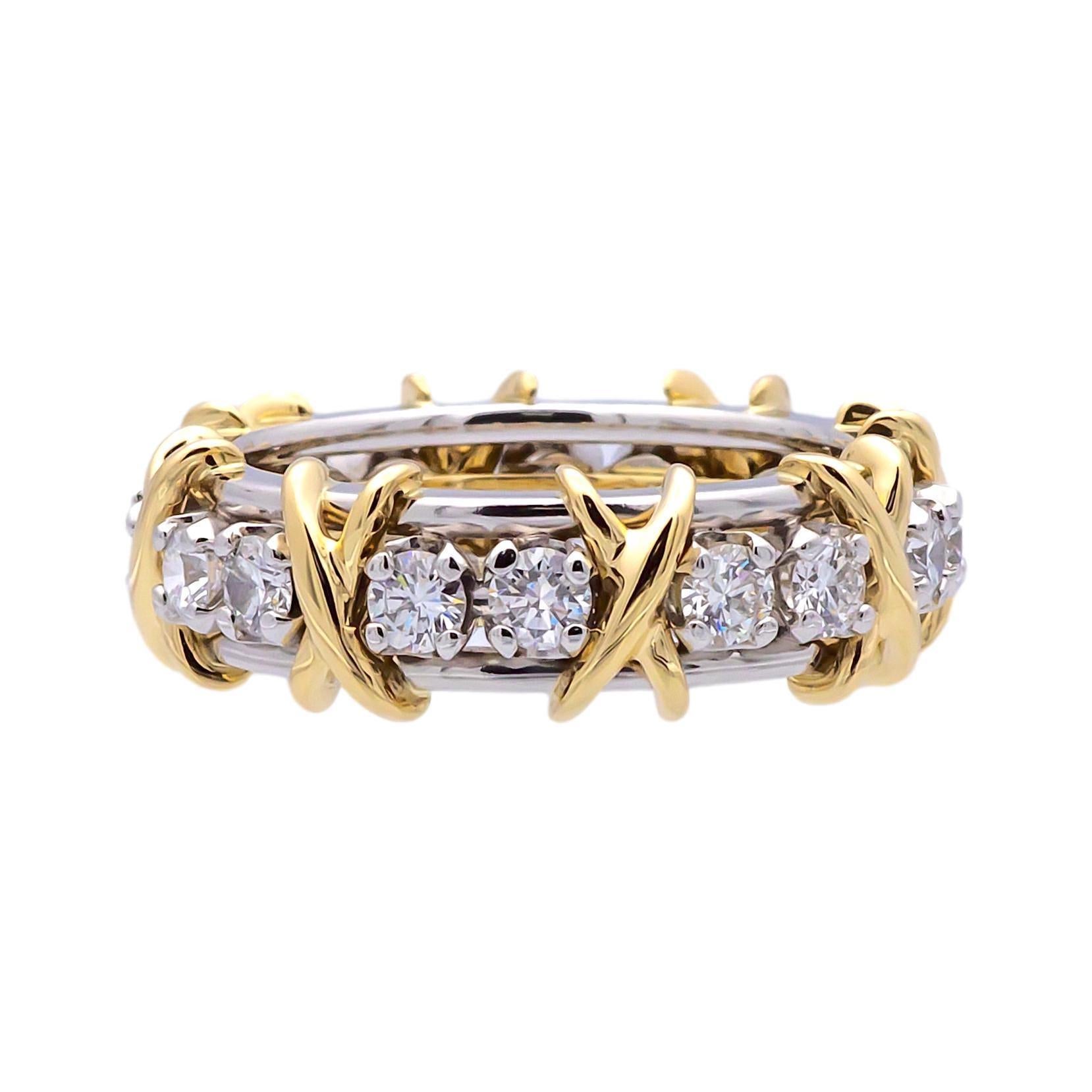 Pre-owned Tiffany & Co. band ring designed by Jean Schlumberger finely crafted in Platinum and 18 Karat yellow gold featuring 16 round brilliant cut diamonds weighing 1.14 carats total weight ,  in F color and very fine VS clarity. Fully hallmarked