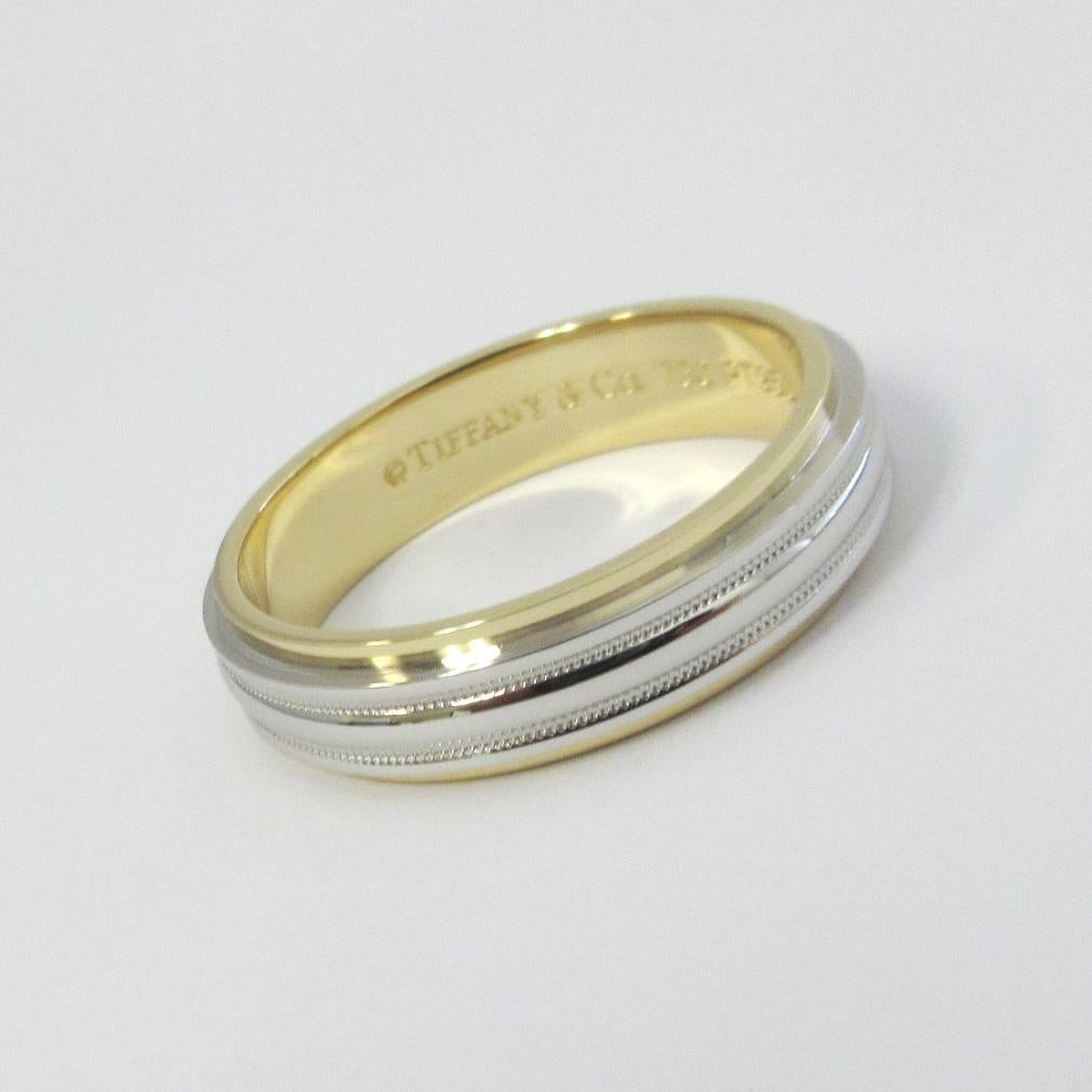 TIFFANY & Co. Platinum 18K Gold 6mm Double Milgrain Wedding Band Ring 12.5

Metal: Platinum and 18K Yellow Gold
Size: 12.5
Band Width: 6mm
Weight: 12.80 grams 
Hallmark: ©TIFFANY&CO. 750 PT950
Condition: Excellent condition, like new

Limited