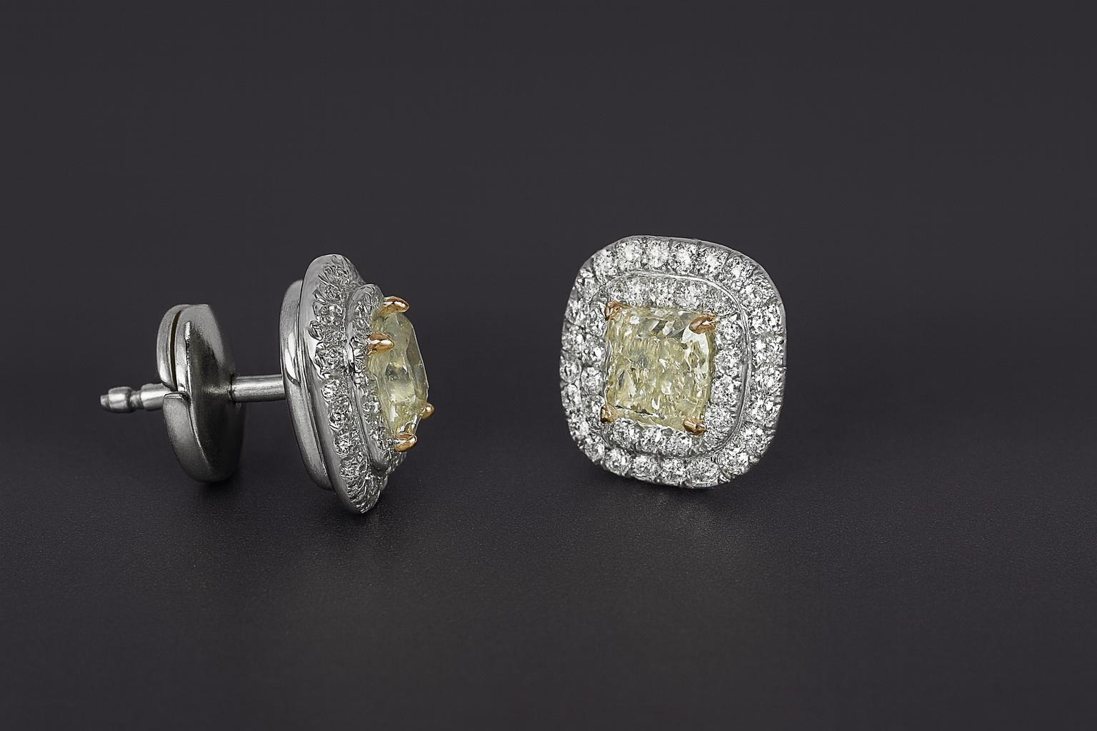 Elegant Tiffany & Co. Soleste earrings crafted in platinum and 18k yellow gold.
Each earring features a cushion-cut fancy yellow diamond weighing approximately 0.50 carats, complemented by a halo of round brilliant pavé-set diamonds that add extra