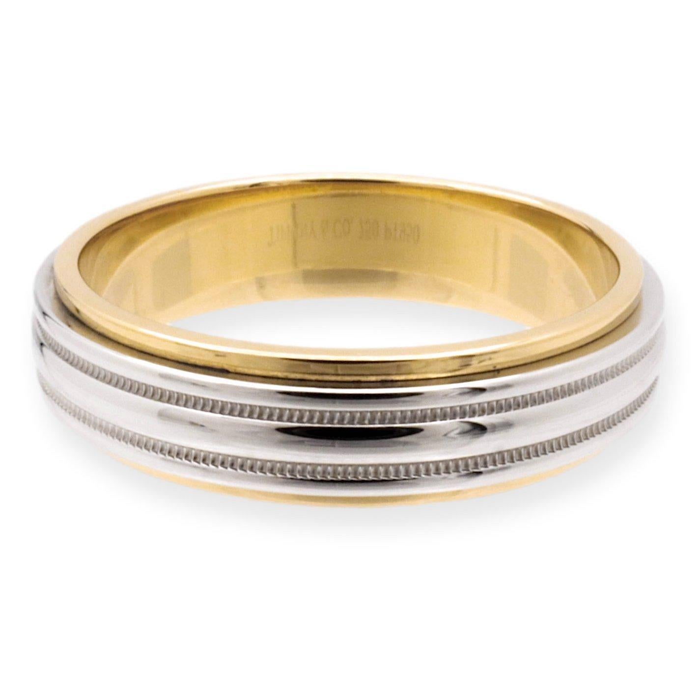 Tiffany & Co. men's wedding band finely crafted in platinum and 18 karat yellow gold from the Together collection with a double mil-grain design. This band is a flat edge band. Fully hallmarked with logo and metal content.

Ring