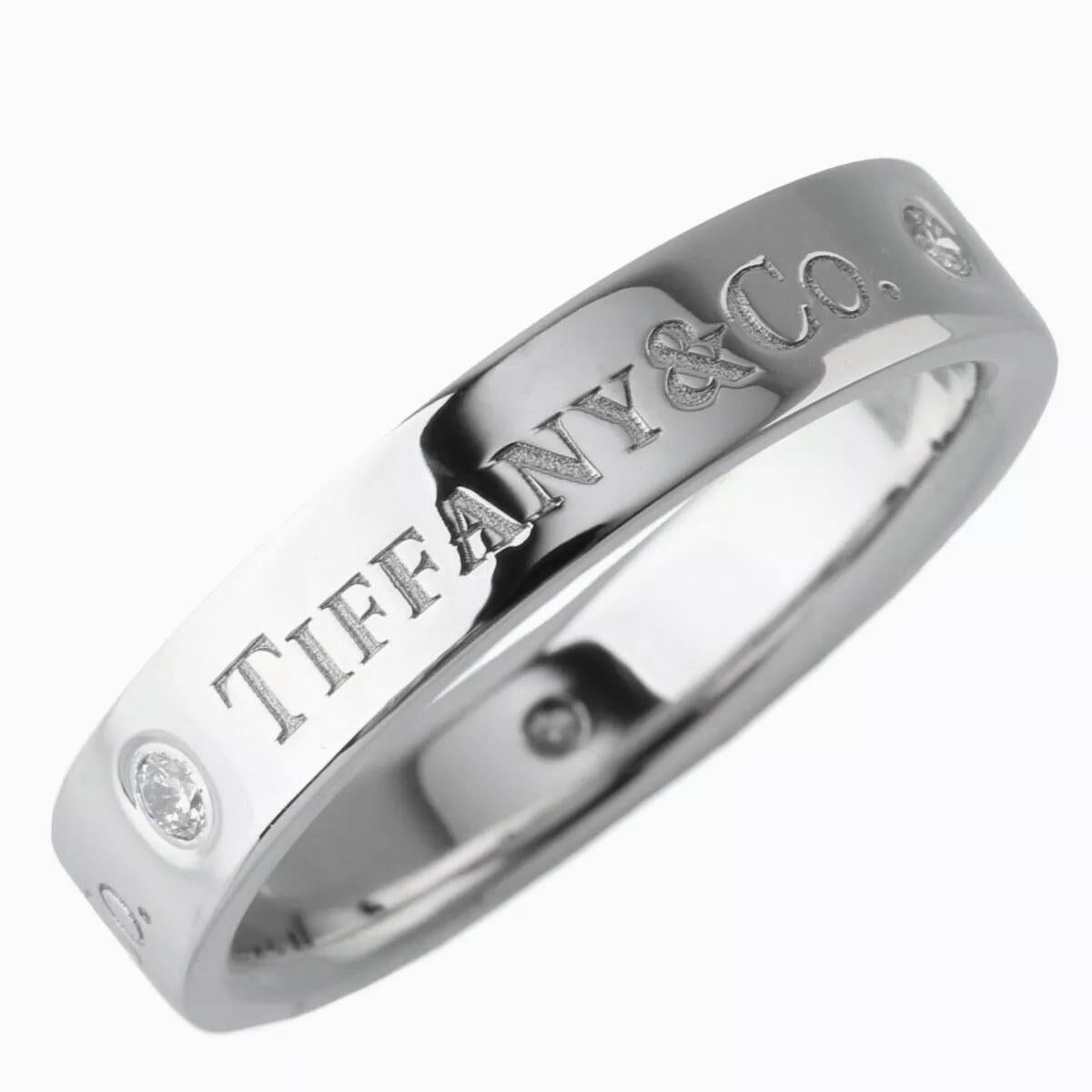 TIFFANY & Co. Platinum 3 Diamond 4mm Wedding Band Ring 7

Metal: Platinum
Size: 7
Weight: 7.60 grams
Band Width: 4mm
Diamond: 3 round brilliant cut diamonds, carat total weight .07
Hallmark: ©TIFFANY&CO. Pt950
Condition: Excellent condition, comes