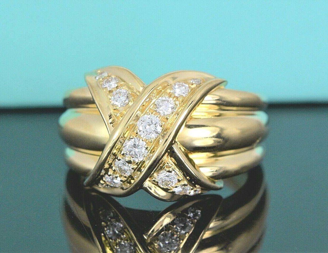 TIFFANY & Co. 18K Gold Diamond Signature X Ring 10.5
 
 Metal: 18K Yellow Gold
 Size: 10.5
 Width: 13mm at the widest point on the top
 Weight: 13.10 grams
 Diamond: 14 round brilliant diamonds, carat total weight .35 approx.
 Hallmark: ©1990