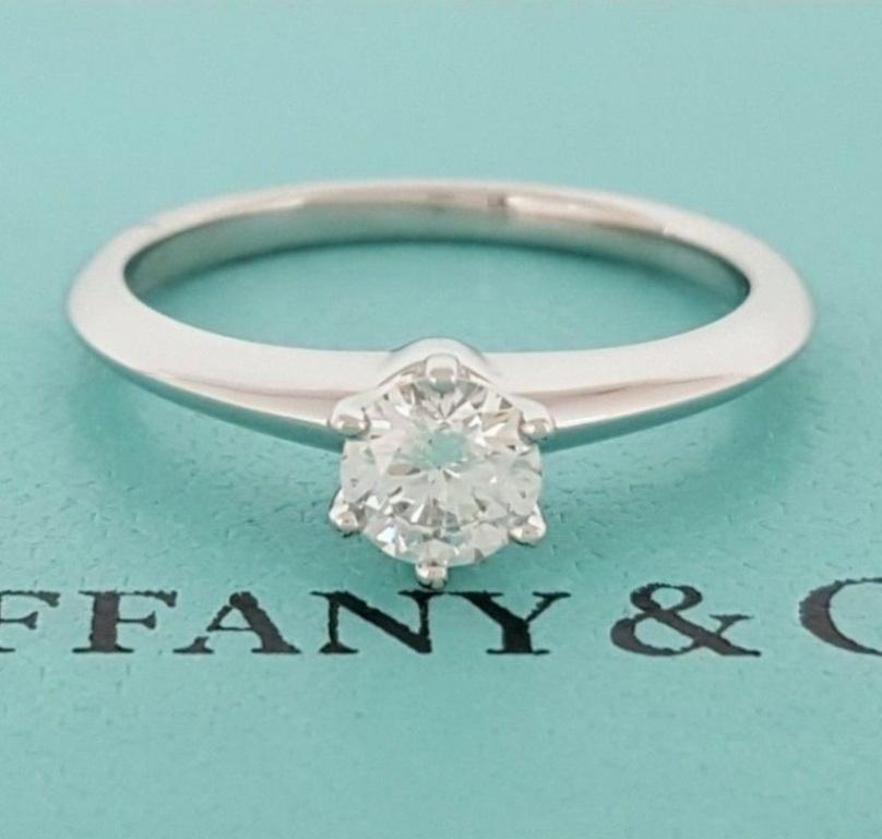 TIFFANY & Co. Platinum .40ct Diamond Engagement Ring 6

Metal: Platinum
Size: 6
Diamond: Round brilliant diamond, carat total weight .40ct, Color I, Clarity VS1
Hallmark: ©TIFFANY&Co. PT950  20004568  .40CT
Condition: Excellent condition. It comes
