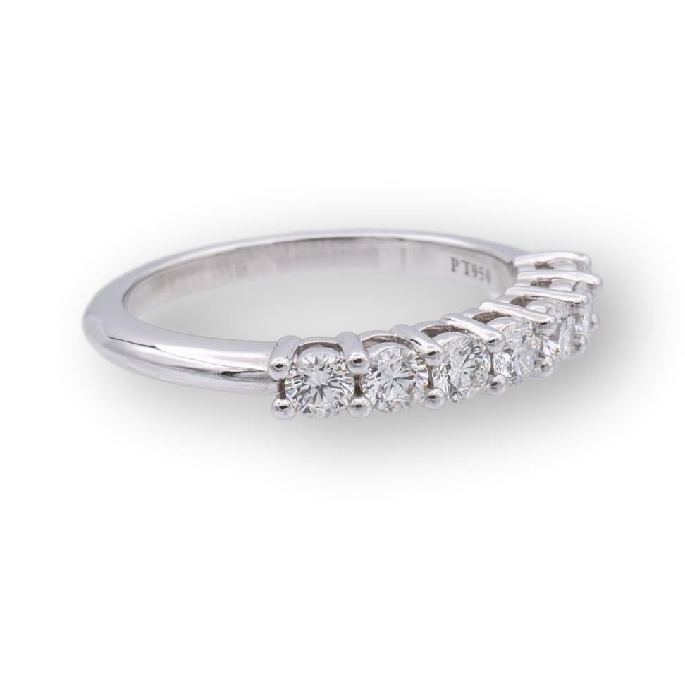 Tiffany & Co. Embrace Half Band ring finely crafted in platinum with 7 Round Brilliant cut diamonds weighing .57 carats total weight. Very bright E-F color , VVS2-VS clarity. The diamonds have excellent brilliance and fire. Fully hallmarked with