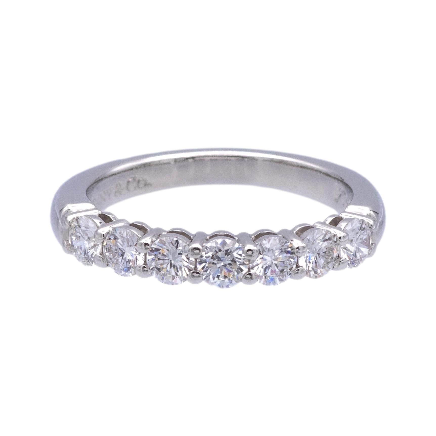Tiffany & Co. Half Band ring from the Forever collection finely crafted in platinum featuring 7 Round Brilliant cut diamonds set in shared prongs weighing .57 carats total weight. Very bright F-G color , VS clarity. 
Ring measures 3mm wide and is
