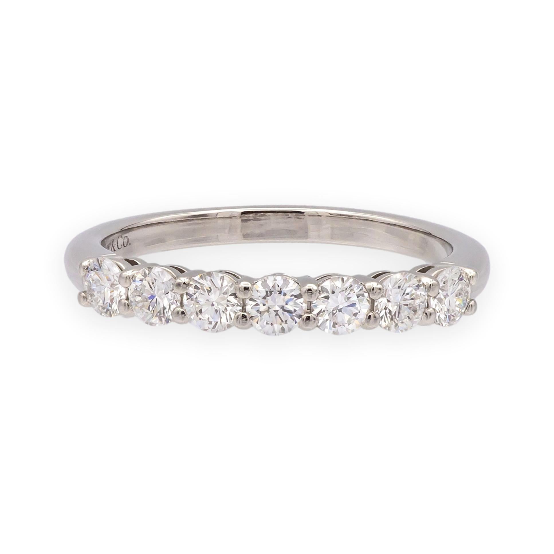This elegant Tiffany & Co. Forever Half Circle Diamond Band is finely crafted in platinum and features seven round brilliant cut diamonds totaling 0.57 carats. The diamonds are set in a classic shared prong design for maximum light return, making it