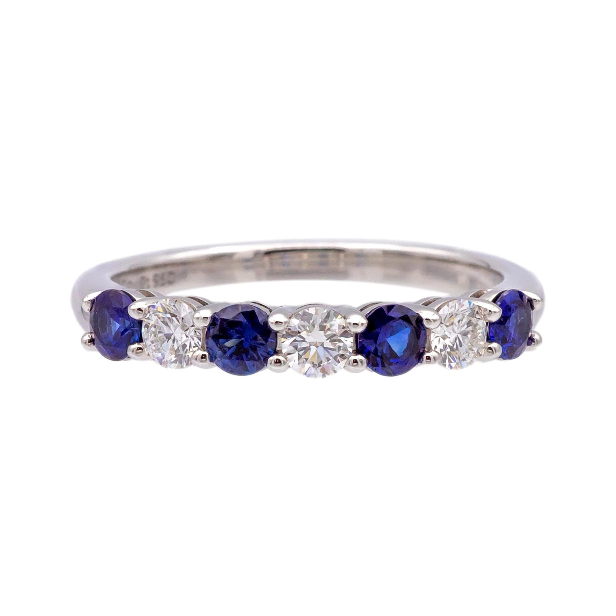 This Tiffany & Co. Forever half circle Band features a classic Tiffany design with alternating sapphires and diamonds. The ring is made of platinum and includes three round brilliant-cut diamonds and four round sapphires, with a total combined carat