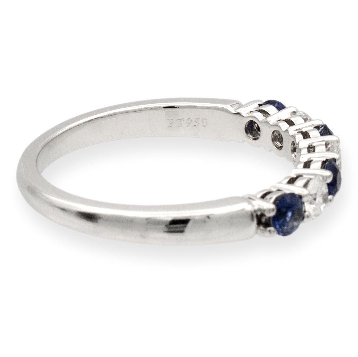 Tiffany & Co. Forever Half Band ring finely crafted in platinum featuring 7 Round Brilliant cut diamonds set in shared prongs weighing .24 carats total weight interlocking with round sapphires weighing a total of .40 carats in a deep blue color. The
