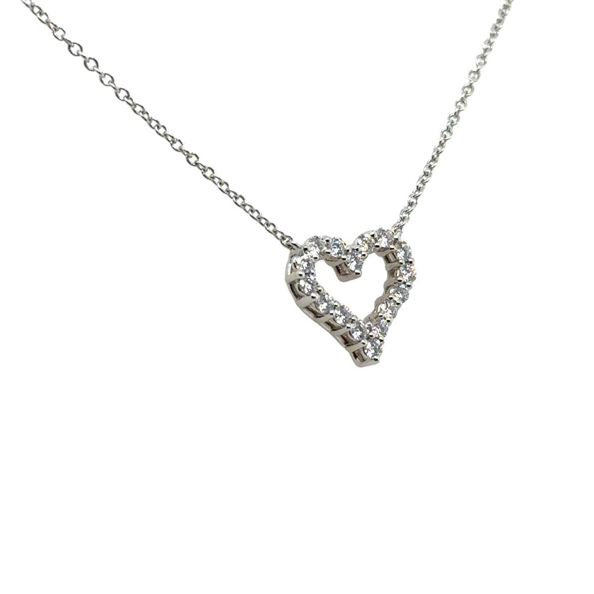 Elegant Tiffany & Co. diamond heart pendant necklace crafted in 950 platinum. The necklace showcases a heart shaped pendant set with 16 round brilliant cut diamonds that show F color with Vs clarity. The pendant is set with 0.25 carat of earth mined