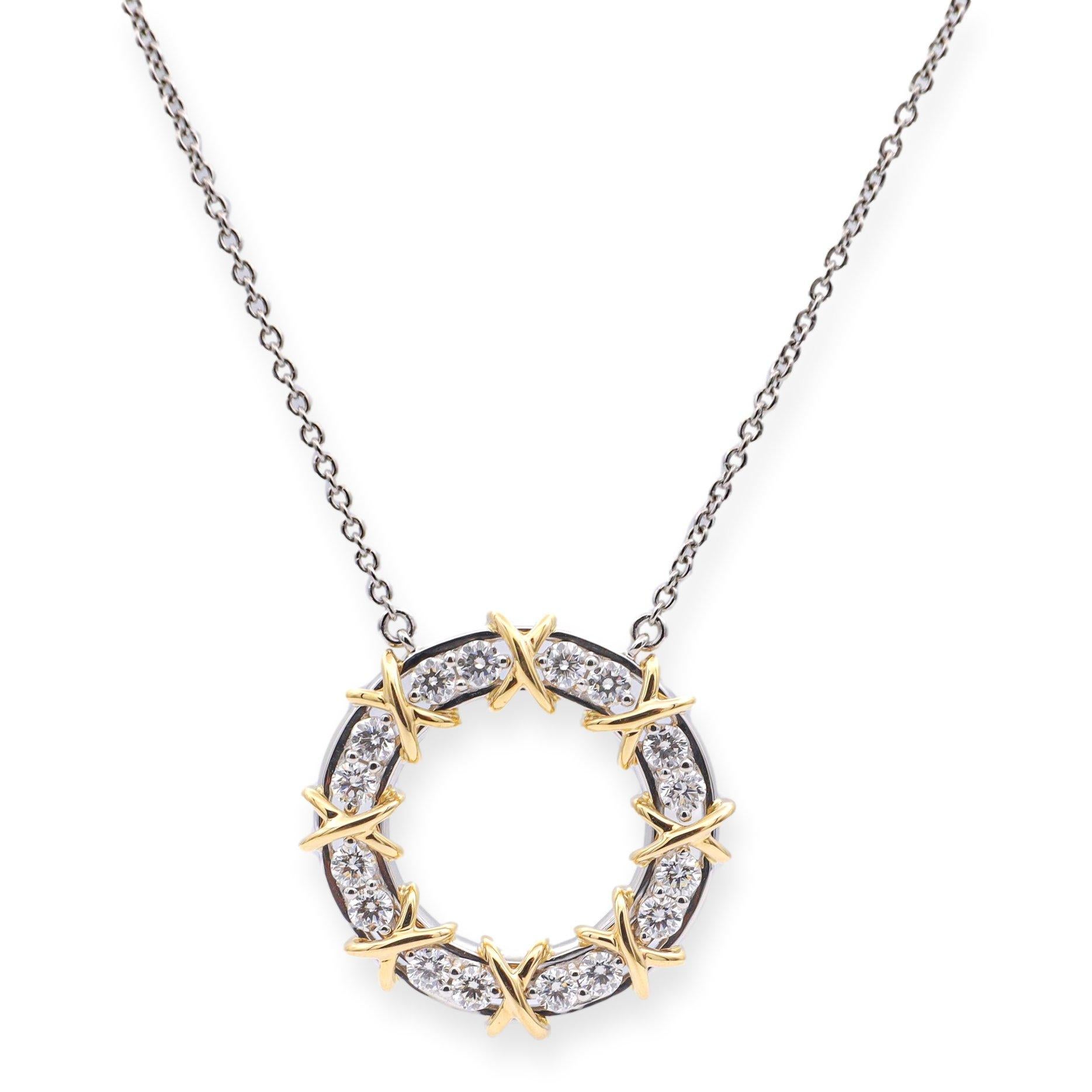 Tiffany & Co. sixteen stone pendant from the Jean Schlumberger collection finely crafted in platinum and 18 karat yellow gold featuring 16 round brilliant cut diamonds weighing 0.57 carats total weight set in shared prongs interlocking with gold X
