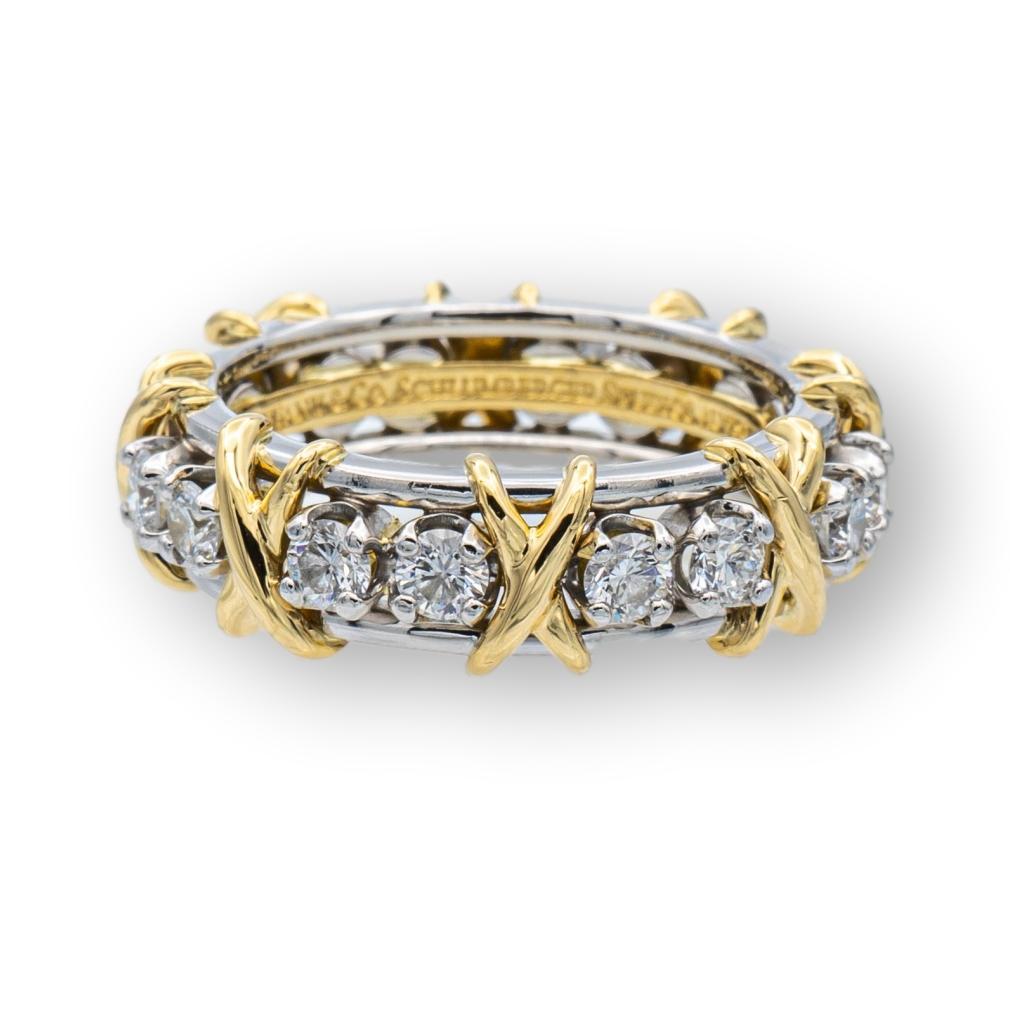 Tiffany & Co. band ring designed by Jean Schlumberger finely crafted Platinum and 18 Karat yellow gold featuring 16 round brilliant cut diamonds weighing 1.14 carats total weight approximately in F color and very fine VS clarity.

Ring