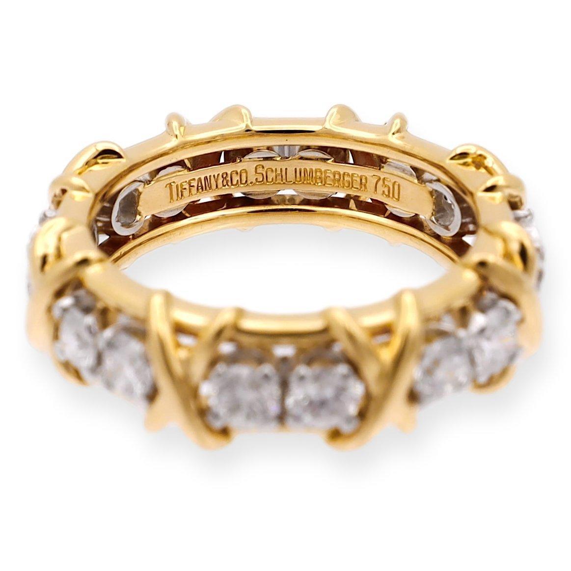 Tiffany & Co. band ring designed by Jean Schlumberger finely crafted Platinum and 18 Karat yellow gold featuring 16 round brilliant cut diamonds weighing 1.14 carats total weight approximately in F color and very fine VS clarity.

Ring