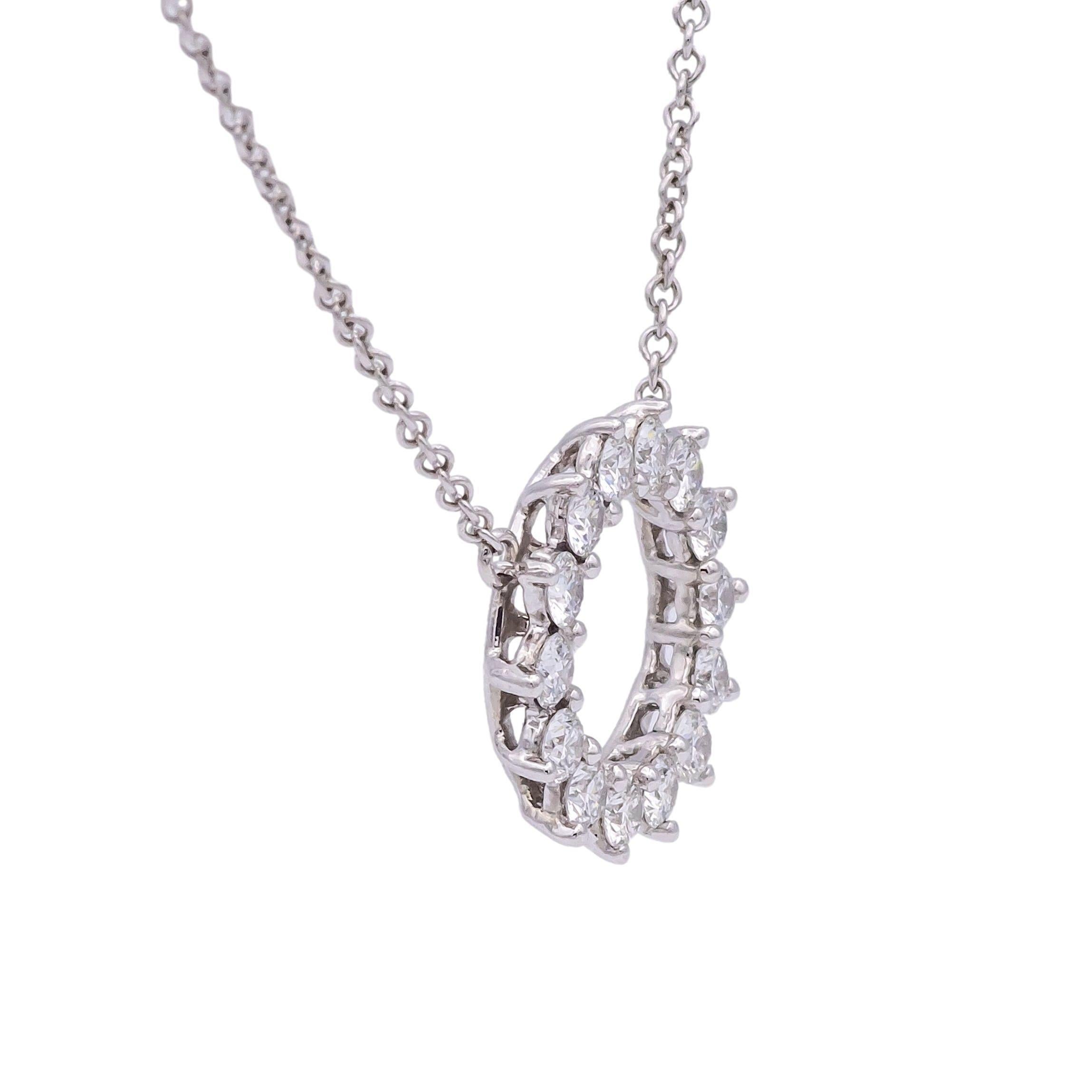 This pre-owned Tiffany & Co. Open Circle Diamond Pendant is crafted in platinum and features 14 diamonds of F color with VS and VVS clarity. The diamonds are set with shared prongs, designed to enhance their brilliance and showcase Tiffany's