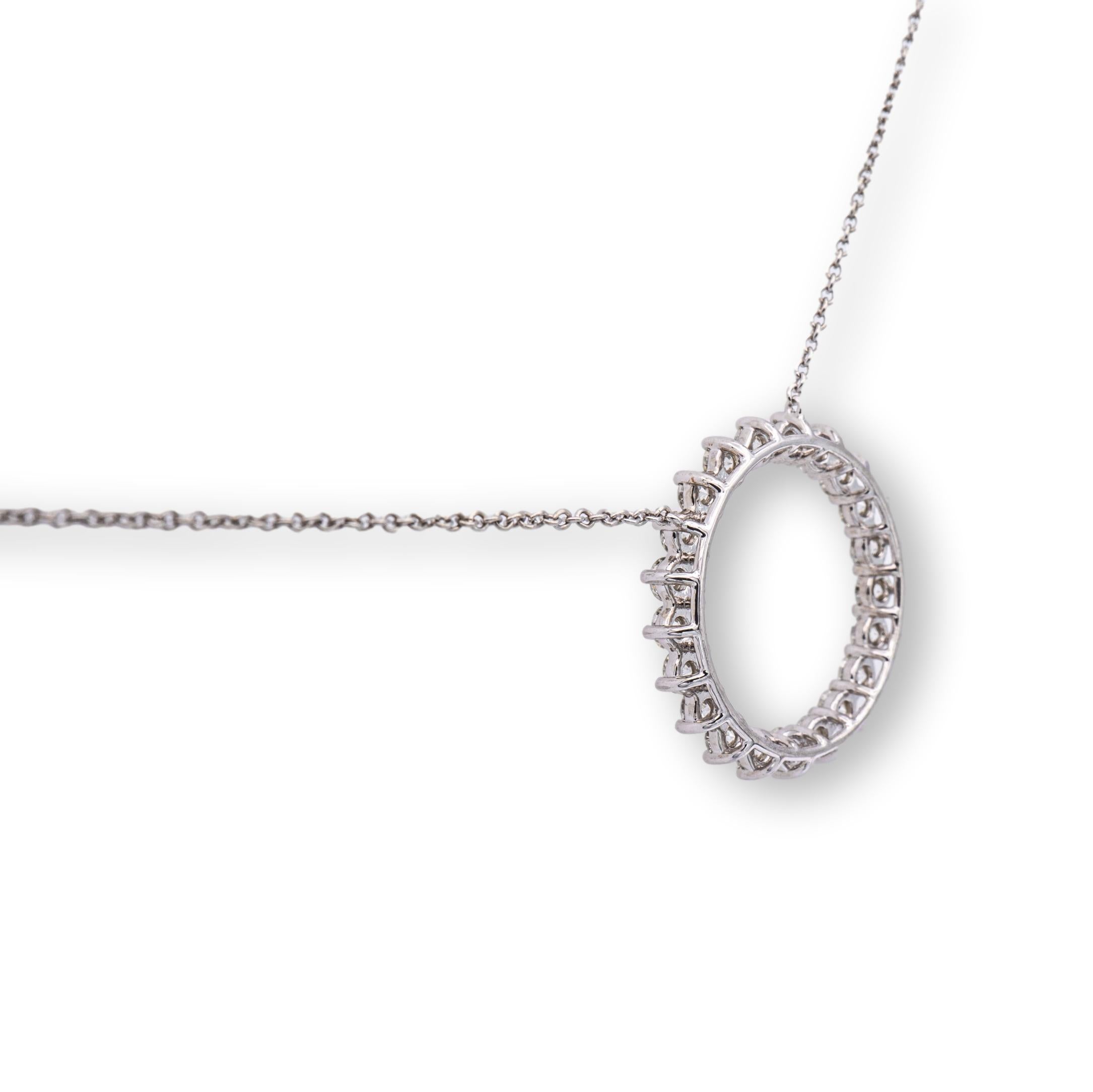 Tiffany & Co. necklace finely crafted in platinum featuring an open circle pendant set with 21 prong set round brilliant cut diamonds weighing 0.93 carats total weight, F color , VS clarity hanging off a 16