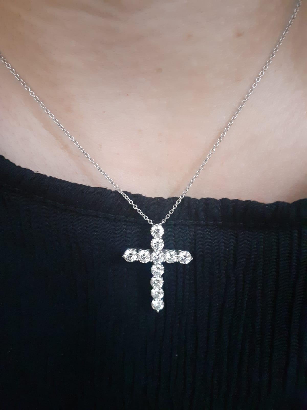 A Tiffany & Co. platinum and diamond cross pendant and chain, circa 2000.

The cross is composed of 11 perfectly matched claw set round brilliant cut diamonds for a total of 1.98 carats approximately, estimated as F colour, VVS2 clarity.

On a