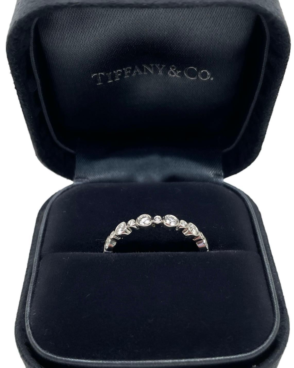 This classic ring from the Tiffany & Co. Jazz Collection contains 26 top quality round brilliant cut diamonds weighing approximately 1.00 carat total. Mounted in platinum, this bezel set, low profile band is a perfect addition to your ring
