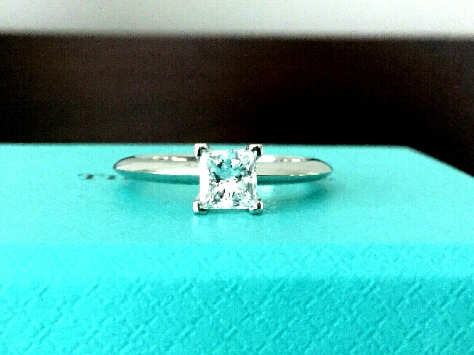 For your consideration is a Tiffany & Co Princess cut .57 carat natural diamond solitaire.  This stunning ring is in BRAND NEW condition and does not look like it was ever worn.  In addition it is truly INVESTMENT GRADE as it is D color and VS2