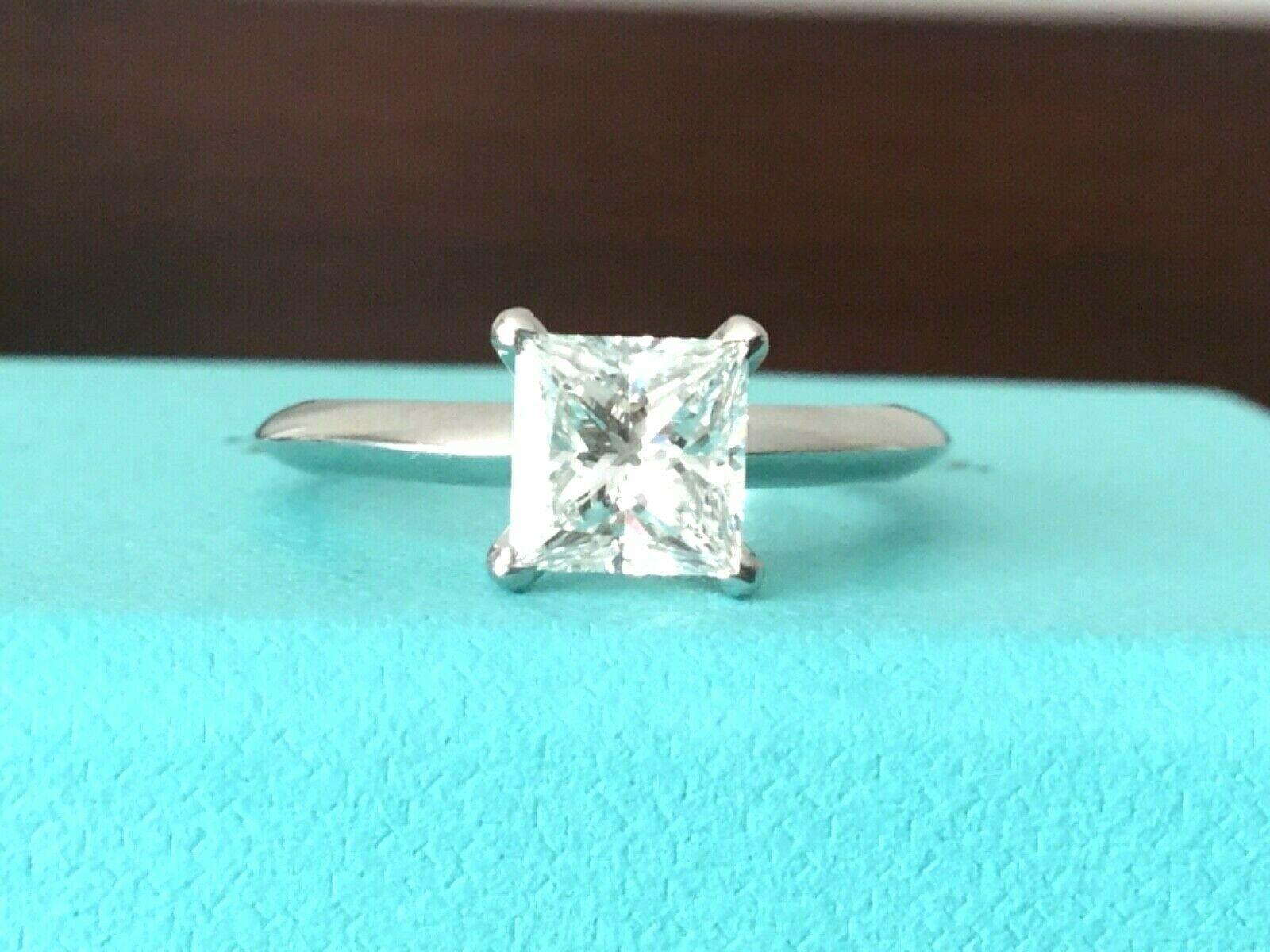 For your consideration is a stunning INVESTMENT GRADE F Color Triple Excellent Tiffany & Co Princess cut 1.26 carat natural diamond solitaire.  The ring shows like a brand new ring with no marks, scratches or nicks.  
This amazing ring retails at