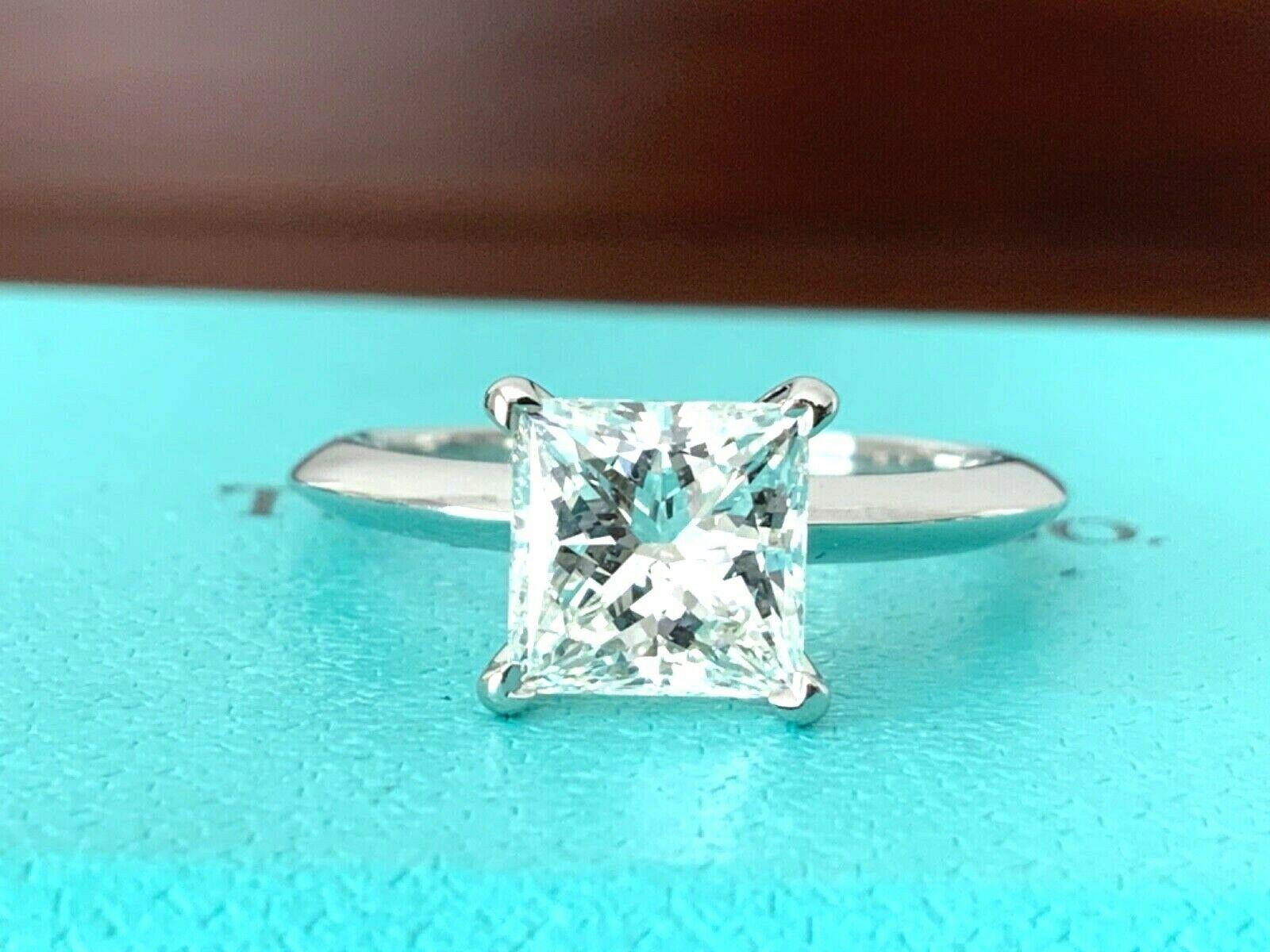 For your consideration is a stunning LARGE CARAT INVESTMENT GRADE H Color VS1 Clarity Tiffany & Co Princess cut 1.71 carat natural diamond solitaire.  The ring shows like a brand new ring with no marks, scratches or nicks.  
This amazing ring