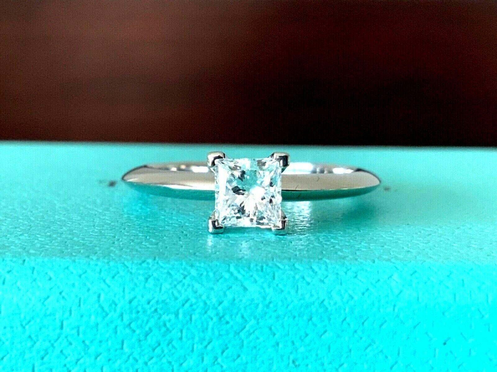 For your consideration is a BRAND NEW Tiffany & Co Princess cut .57 carat natural diamond solitaire.  This stunning ring was purchased for an engagement that never happened - the ring is absolutely BRAND NEW with no marks, nicks or scratches - it