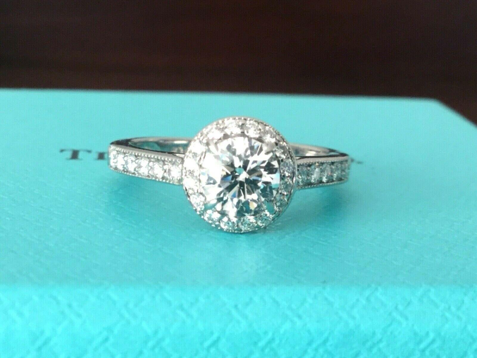 
For your consideration is a Tiffany & Co natural Round diamond halo engagement ring set in platinum.  The center stone is a natural round .51 carat white diamond, E Color, VS1 Clarity and Triple Excellent Cut, Polish and Symmetry making it an