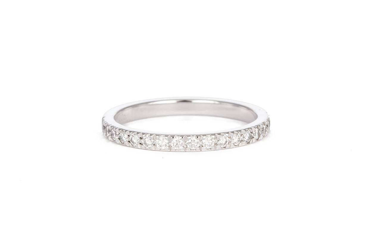 We are pleased to offer this Authentic Platinum & Diamond Tiffany & Co. Wedding Band. It features approximately 0.25ctw F-G/VVS-VS Round brilliant Cut Diamond set in .950 Platinum. It is a size 6 US and measures 2mm wide. The ring is in very good