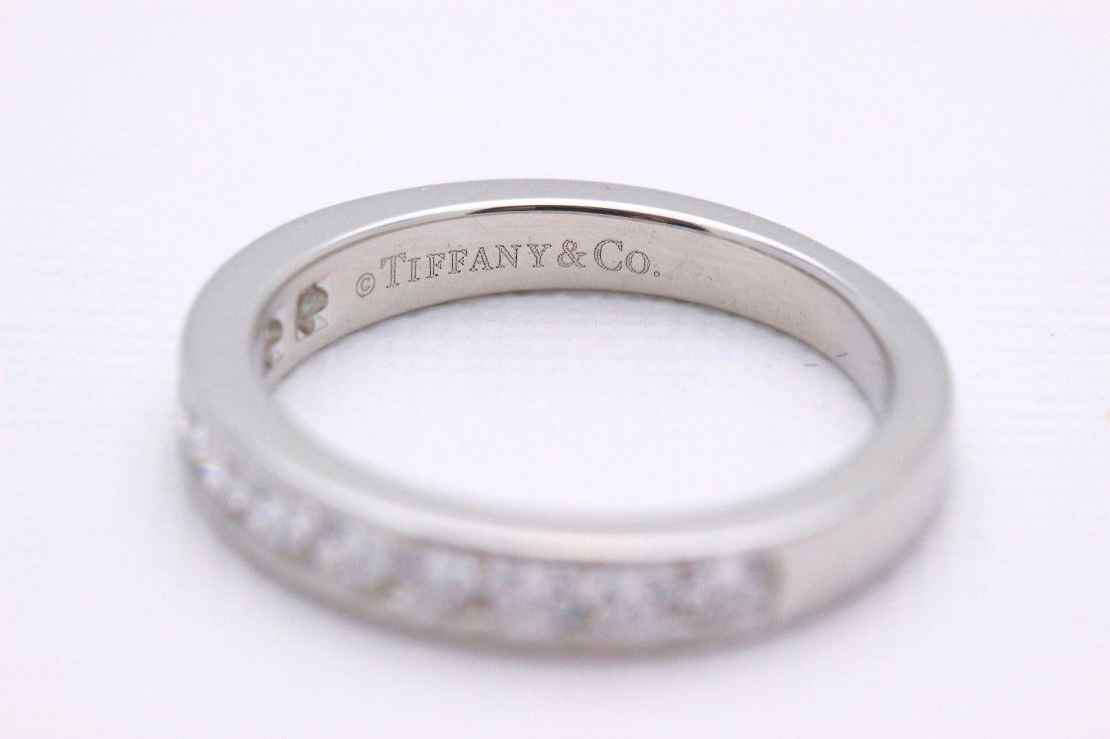 Tiffany & Co.
Style: Half Circle Diamond Wedding Band
Sku Number:  16183334
Size:  4- sizable
Metal:  Platinum PT950
Total Carat Weight:  0.24 Cts.
Diamond Shape:  Round Brilliant 
Diamond Color & Clarity:  F / VS
Hallmark:  