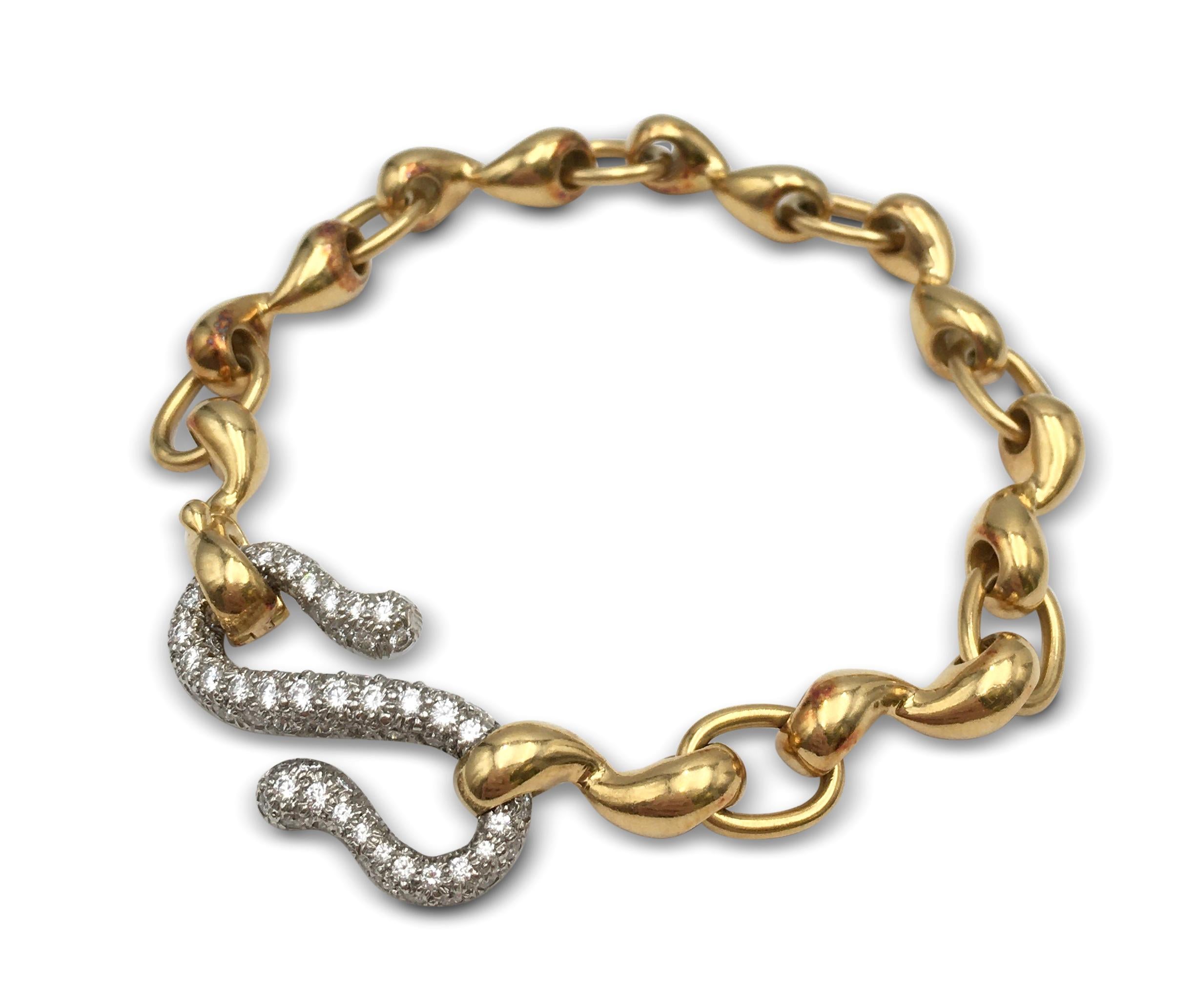 Authentic Tiffany & Co. bracelet crafted in 18 karat yellow gold and platinum features a large 