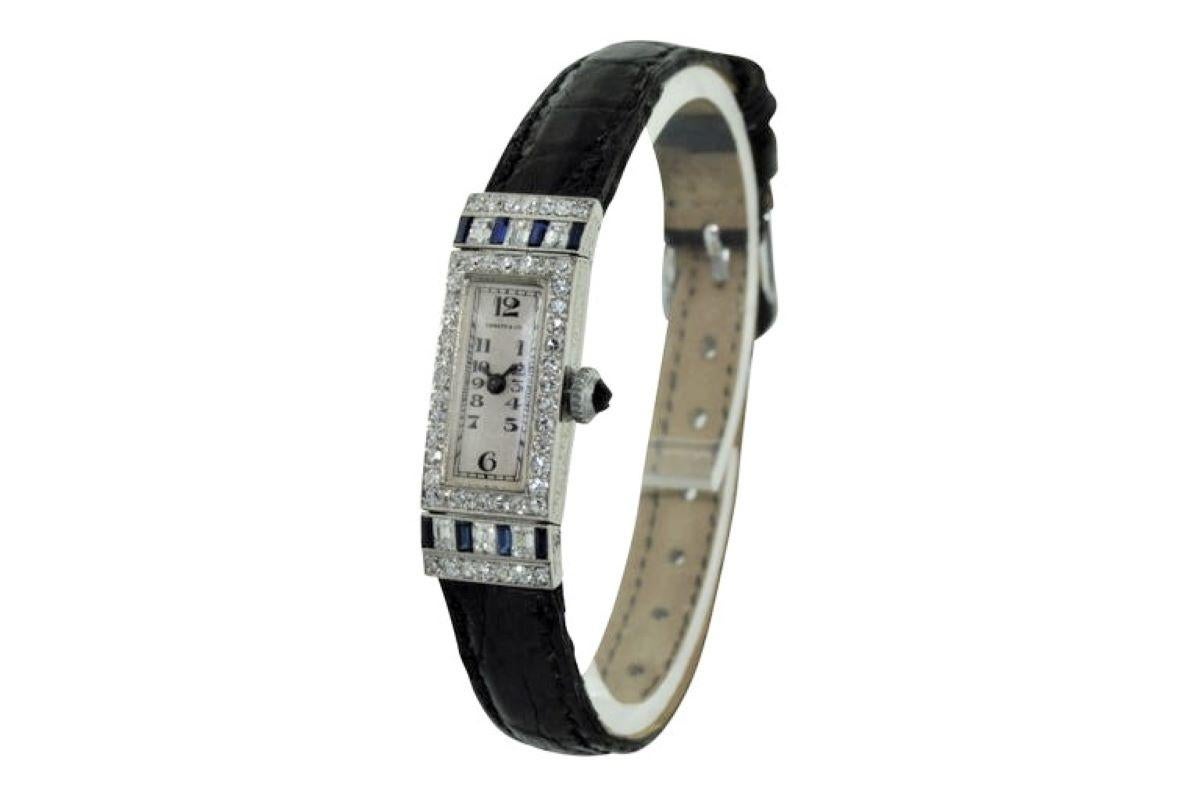 FACTORY / HOUSE: Tiffany &Co. 
STYLE / REFERENCE: Art Deco / Evening Watch
METAL / MATERIAL: Platinum 
DIMENSIONS: 33mm X 12mm
MOVEMENT / CALIBER: Manual Winding / High Grade / 18 Jewels
DIAL / HANDS: Original Silvered with Kiln Fired Enamel