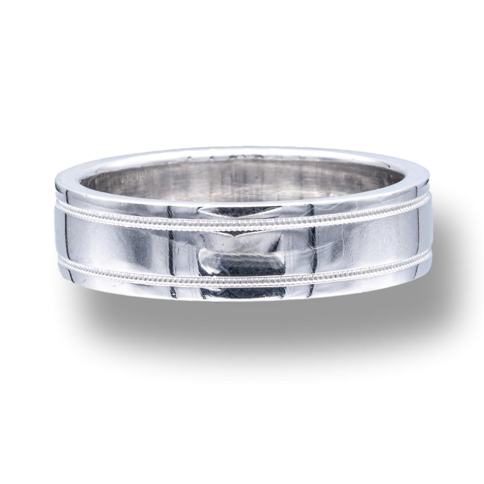 Tiffany & Co. men's wedding band finely crafted in platinum with a double mil-grain design. This band is a flat comfort fit.

Brand: Tiffany & Co.
Hallmarks: Tiffany & Co. PT950
Finger Size: 11
Width: 6mm
Weight: 16.9 grams
Retail: $2,800

Comes in