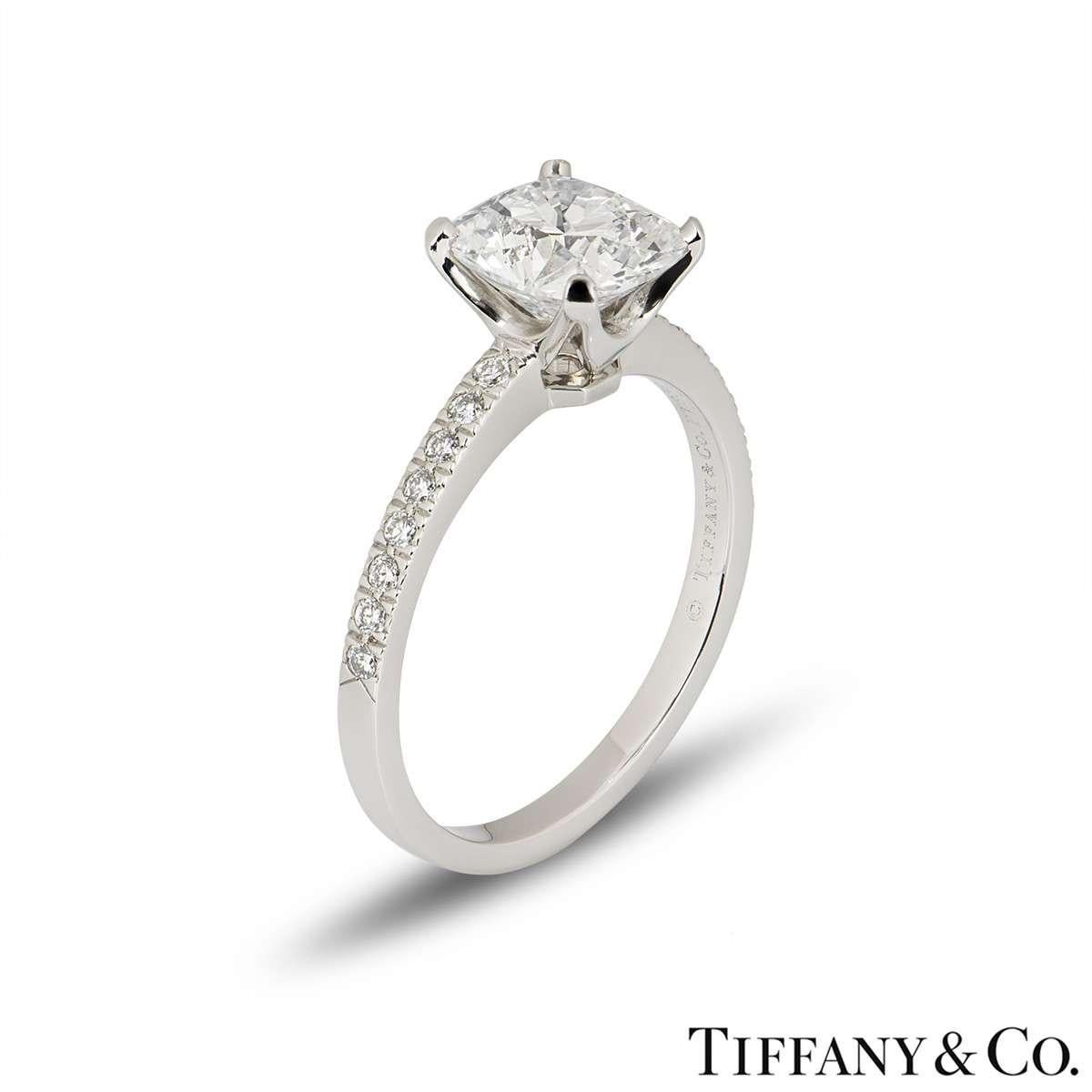 An eye-catching diamond ring in platinum from the Novo collection by Tiffany & Co. The ring is set to the centre with a 2.22ct cushion cut diamond in a classic 4 claw setting. The diamond is G colour and VVS1 clarity. Set to either side of the