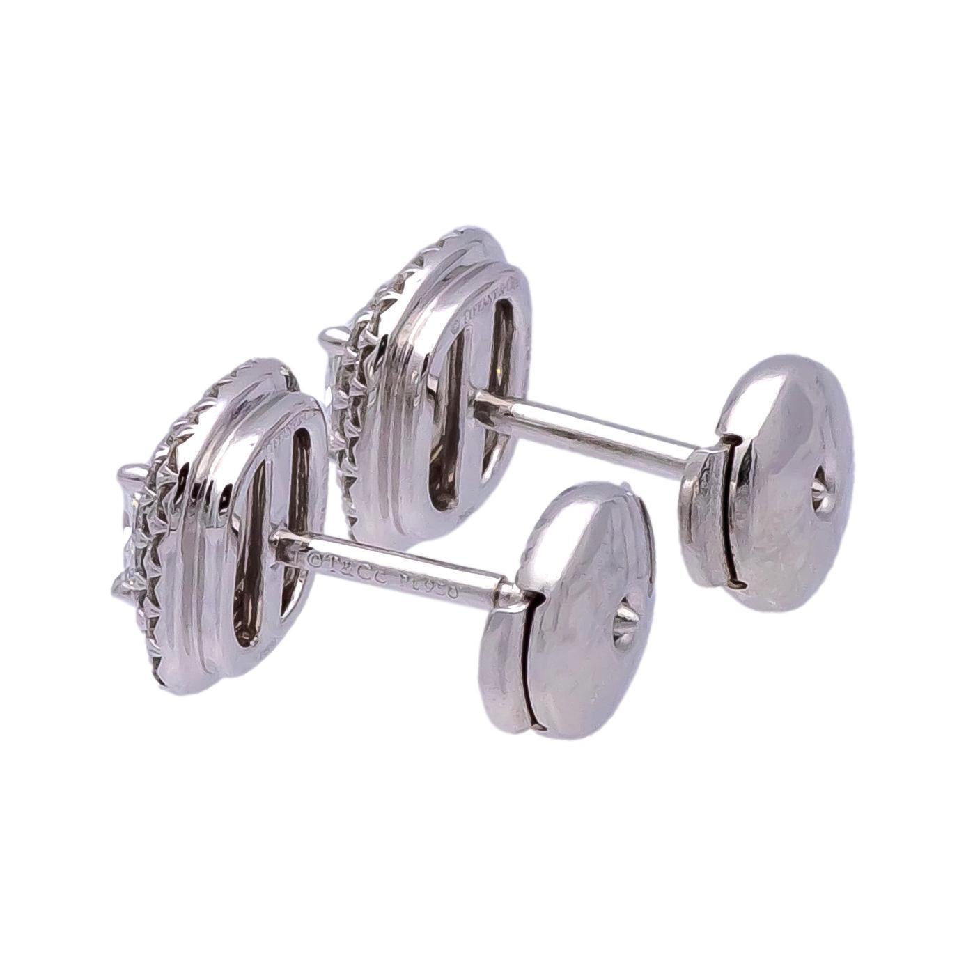 Pair of Tiffany &. Co. stud diamond earrings from the Soleste collection finely crafted in platinum featuring two center cushion brilliant cut diamonds, one weighing 0.34 carats H color, VVS1 clarity and the second weighing 0.35 carats H color, each