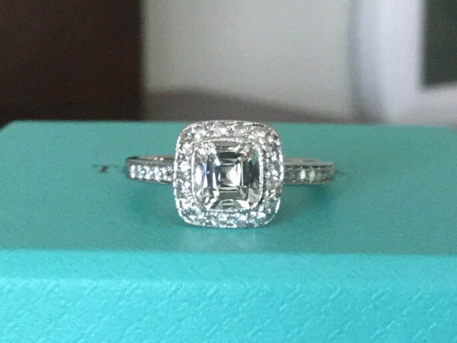 Being offered for your consideration is a like new Tiffany & Co Platinum and Diamond 1.02 carat (1.34 TOTAL CARAT WEIGHT) natural cushion cut diamond engagement ring set in the classic LEGACY pave diamond band..  This ring was hardly worn and can