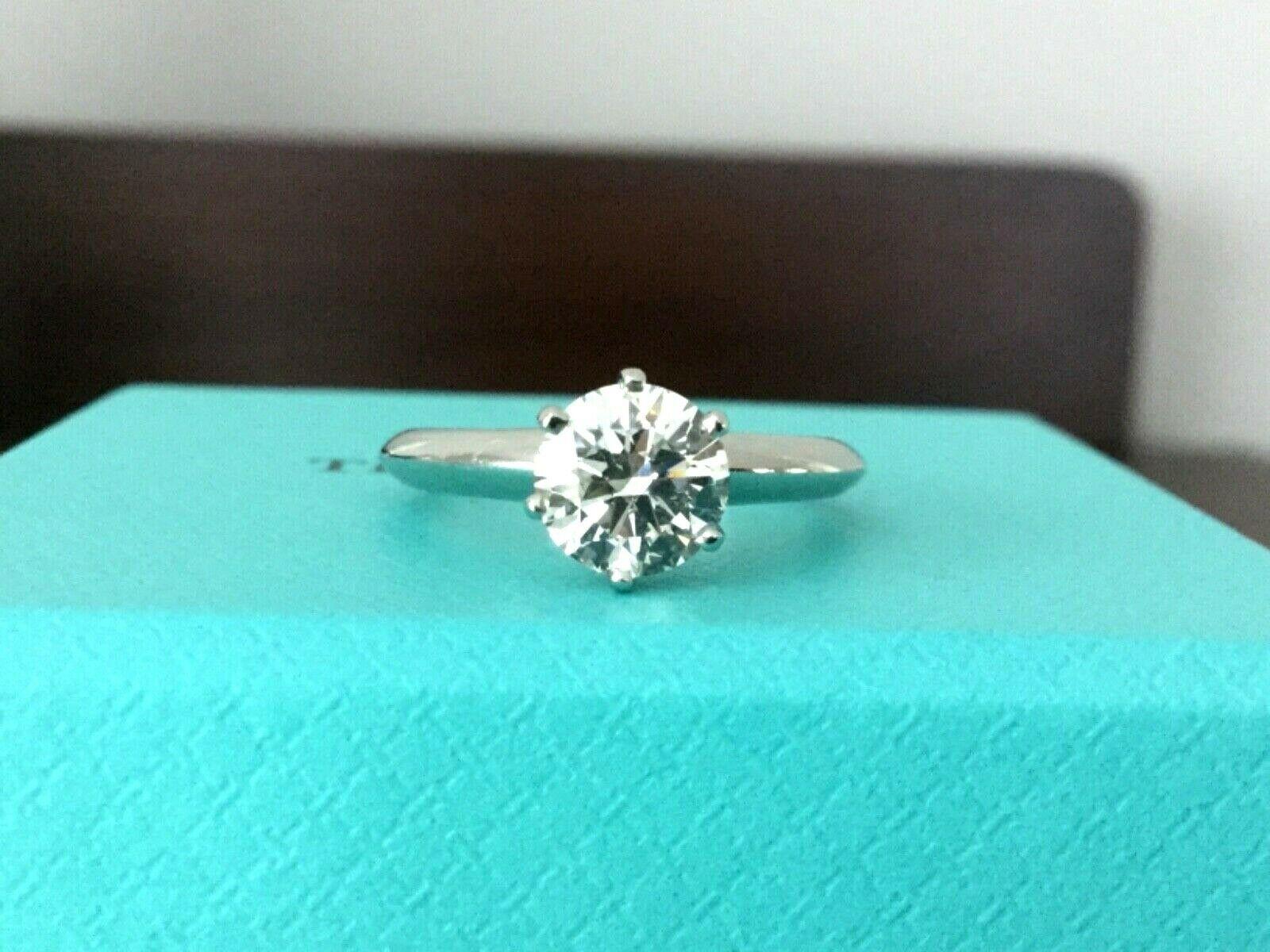 Being offered for your consideration is a like new Tiffany & Co Platinum and Diamond 1.19 carat natural round engagement ring set in the classic 6 prong setting.  

This stunning diamond looks HUGE, Super White and Super Fiery - it is a magnificent