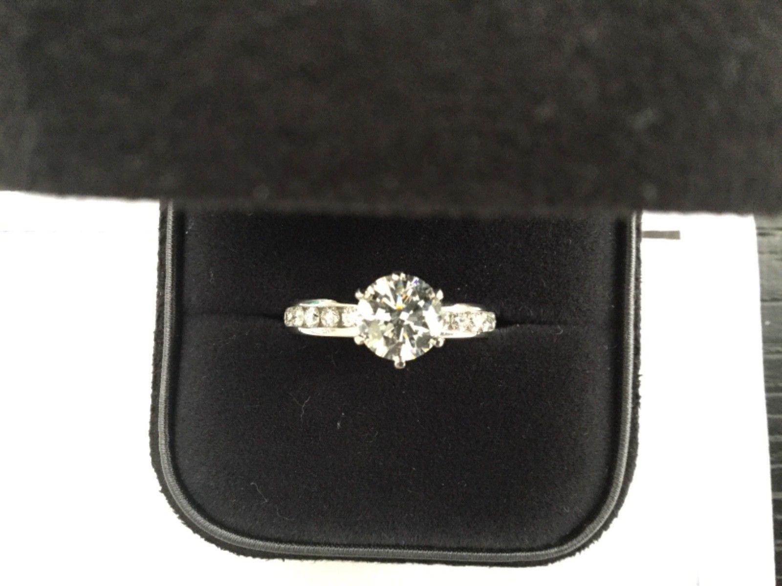 Being offered for your consideration is a like new classic Tiffany & Co Platinum and Diamond 1.24 carat natural Round engagement ring set in the classic channel set diamond band (TOTAL CARAT WEIGHT IS 1.57 carats)..  This ring was hardly worn and