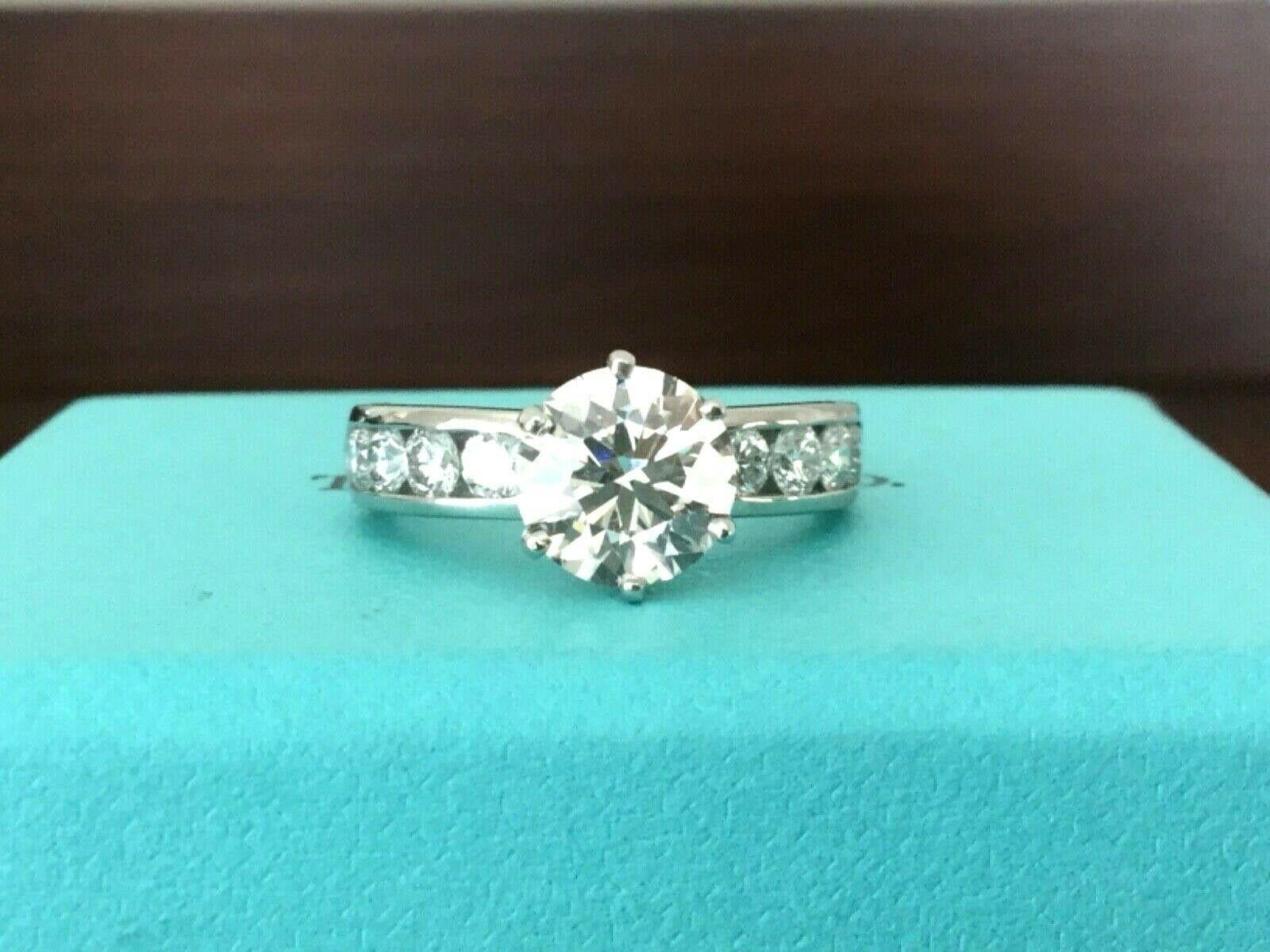 Being offered for your consideration is a like new classic Tiffany & Co Platinum and Diamond 1.47 carat natural Round engagement ring set in the classic channel set diamond band (TOTAL CARAT WEIGHT IS 1.77 carats)..  This ring was hardly worn and