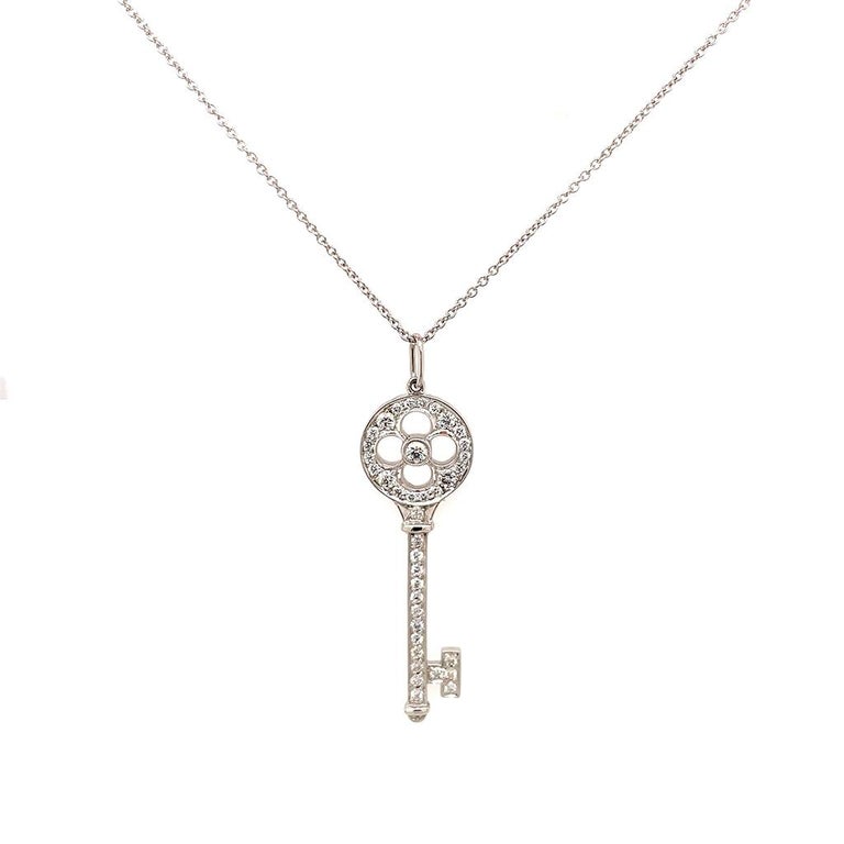 This Tiffany & Co. necklace is crafted of platinum with a 1.5 inch rose key shaped pendant that features diamonds weighing 0.40 carats. It hangs on a 18 karat white gold cable chain that is 18 inches in length.