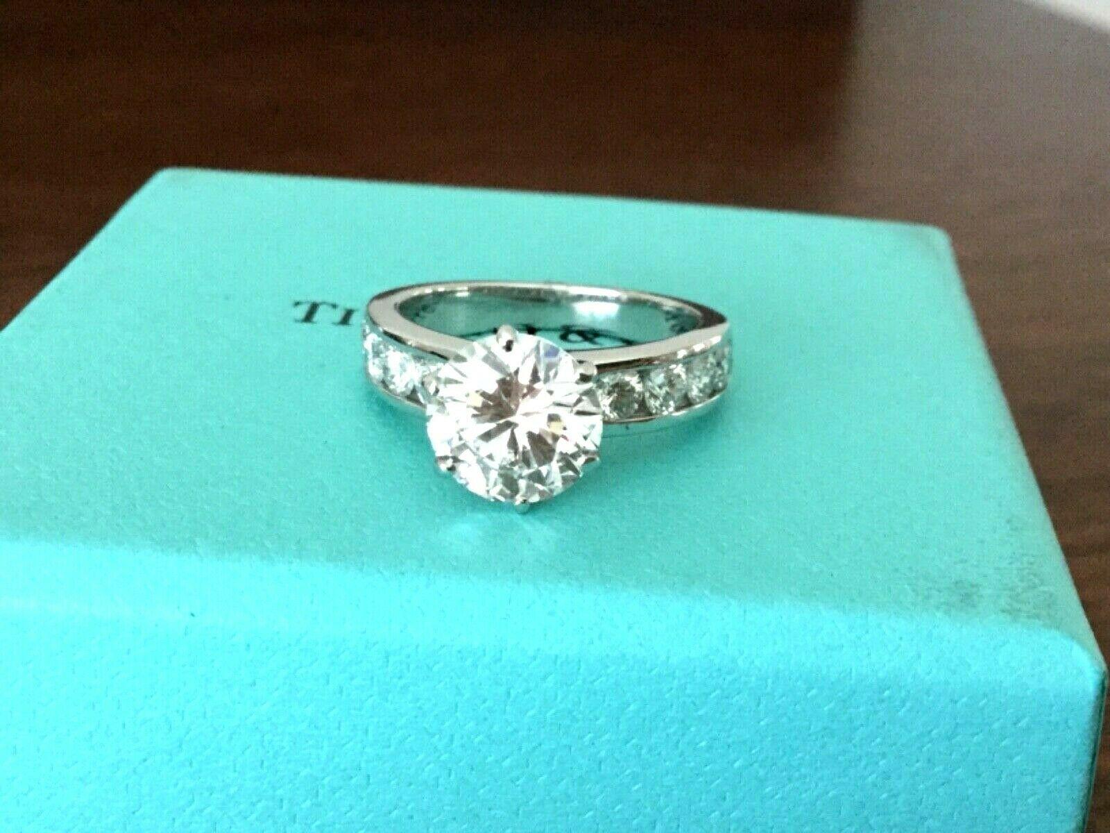 Being offered for your consideration is a like new classic Tiffany & Co Platinum and Diamond 2.14 carat natural Round engagement ring set in the classic channel set diamond band (TOTAL CARAT WEIGHT IS 2.50 carats)..  This ring was hardly worn and
