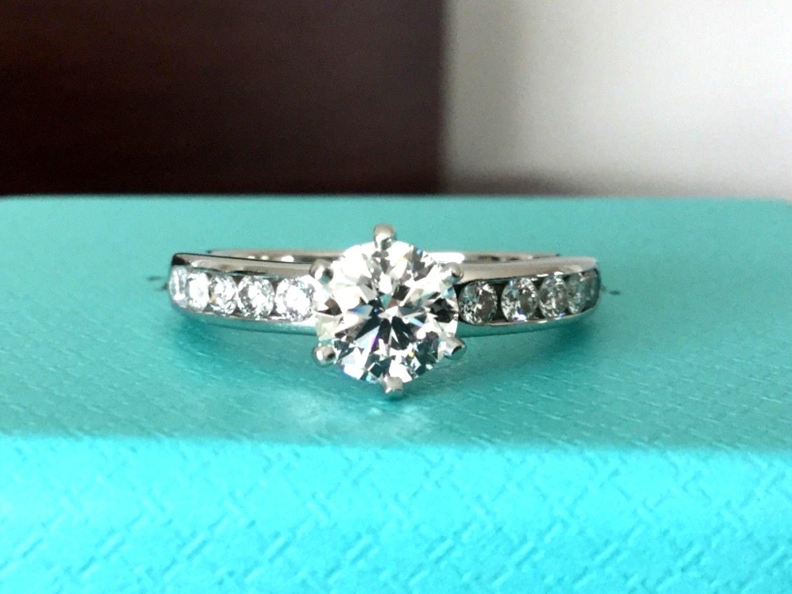 Being offered for your consideration is a like new classic Tiffany & Co Platinum and Diamond .60 carat natural Round engagement ring set in the classic channel set diamond band (TOTAL CARAT WEIGHT IS .82 carats)..  This ring was hardly worn and can