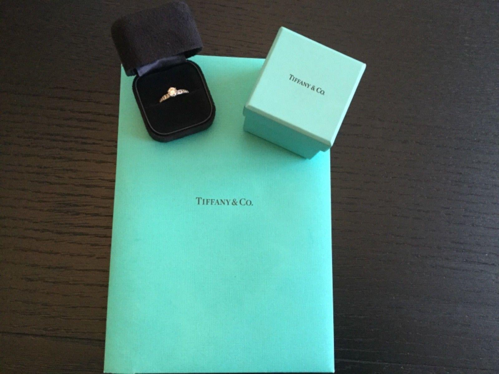 Being offered for your consideration is a like new classic Tiffany & Co Platinum and Diamond .74 carat natural Round engagement ring set in the classic channel set diamond band (TOTAL CARAT WEIGHT IS 1.00 carats)..  This ring was hardly worn and can