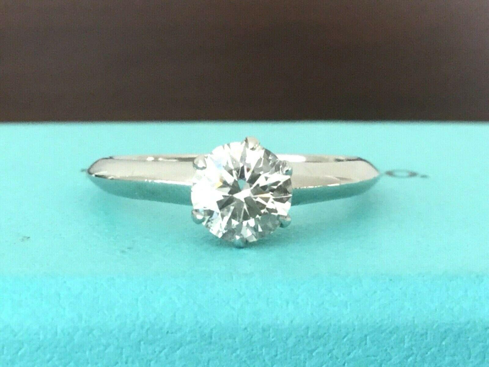 Being offered for your consideration is a like new Tiffany & Co Platinum and Diamond .77 carat natural round engagement ring set in the classic 6 prong setting.  This stunning ring is a TRUE INVESTMENT grade diamond ring - being F Color, VS2 Clarity